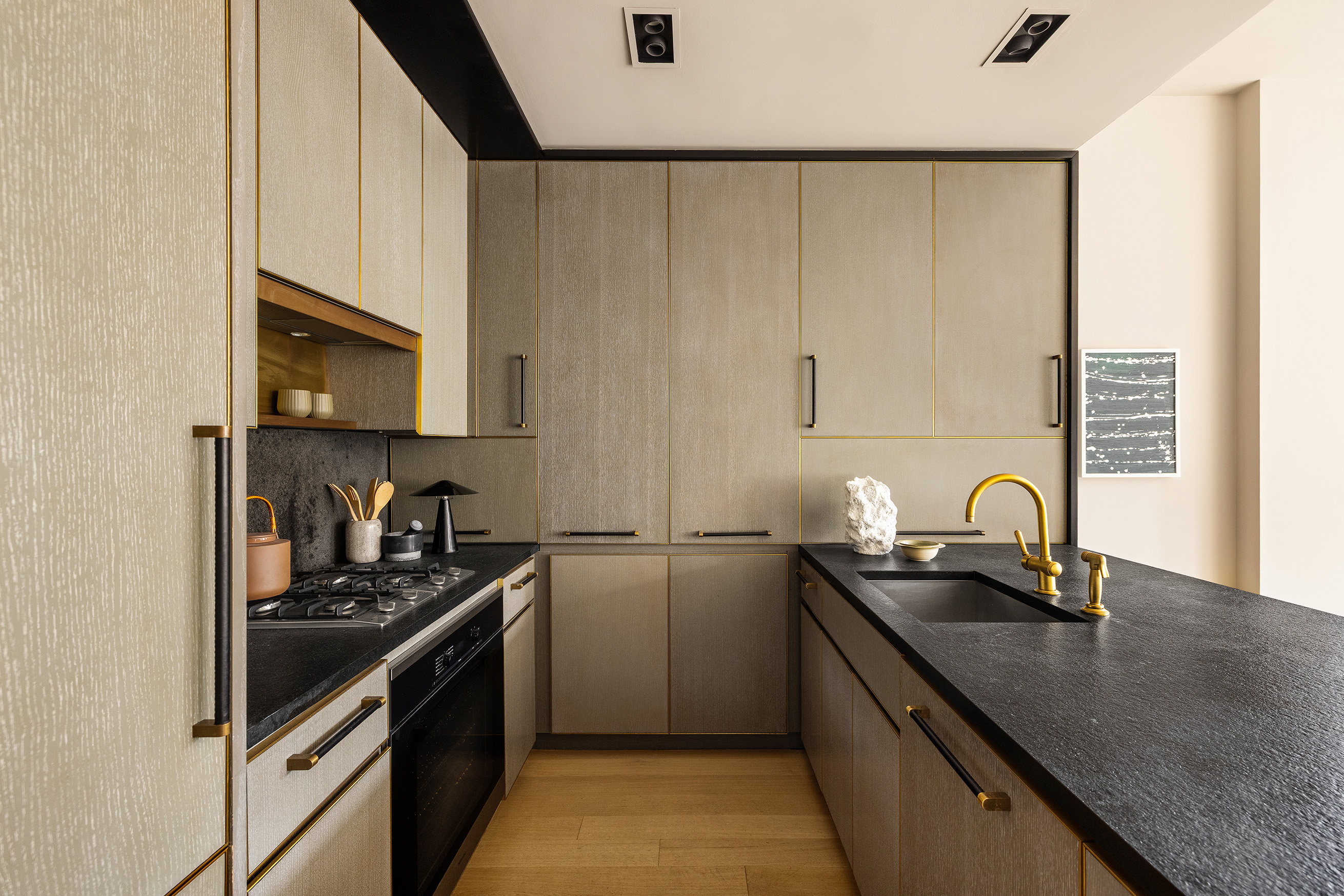 505 West 19th Street, Unit 5D Manhattan, NY 10011 - Photo 5 of 17 a kitchen with granite countertop a sink a stove and refrigerator