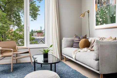a balcony view with a couch and table chair