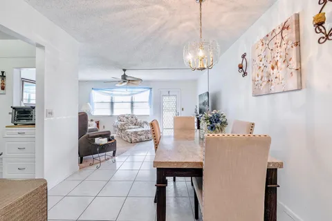 a view of a dining room with furniture and a chandelier