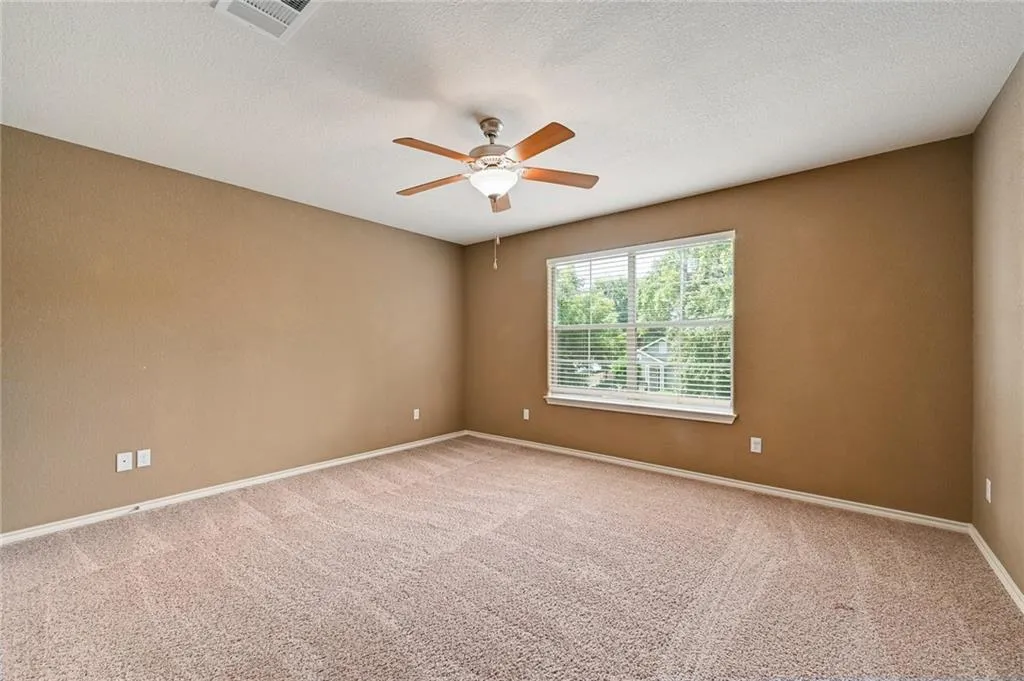 a view of room with a ceiling fan and window