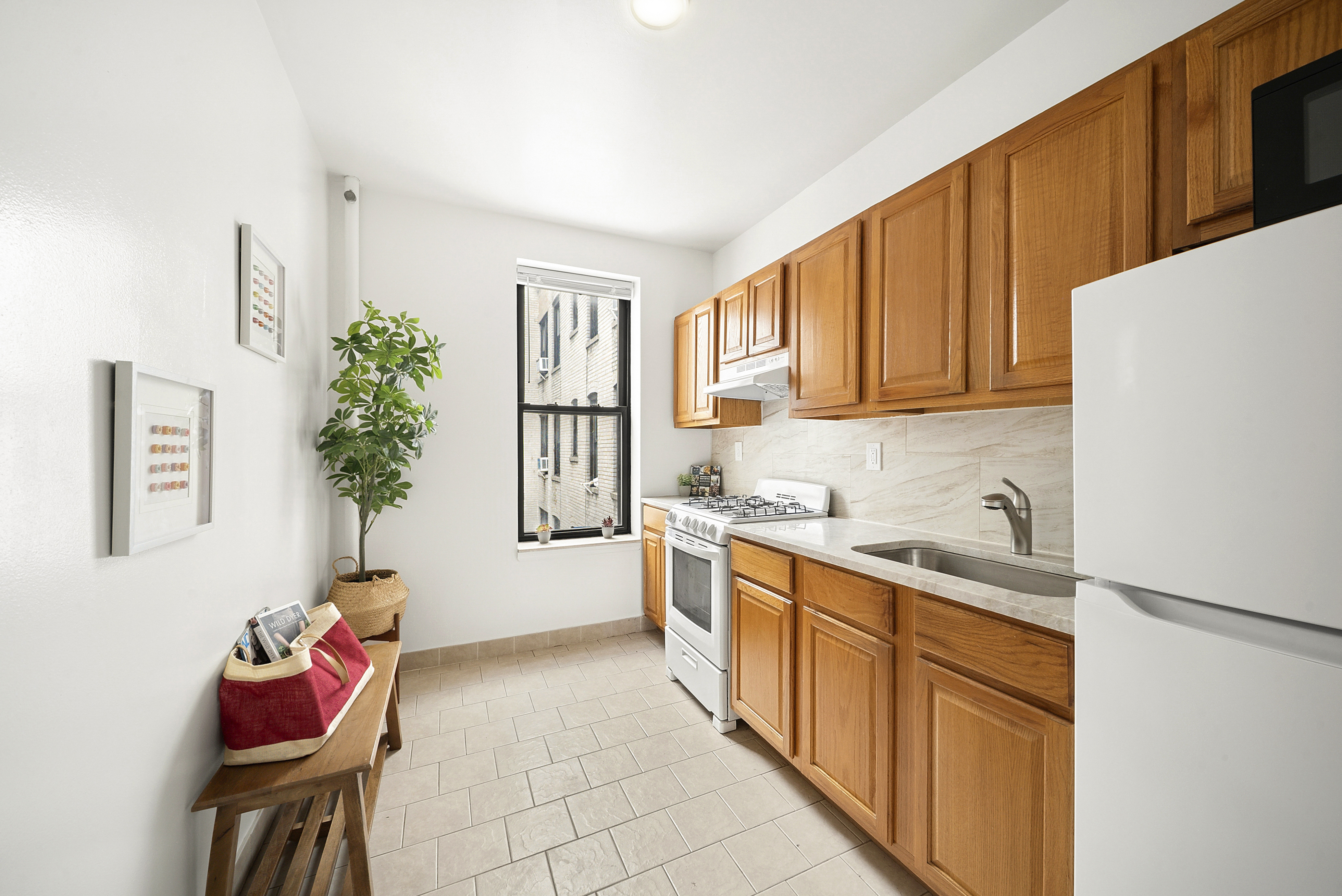 325 Marine Avenue, Unit D10 Brooklyn, NY 11209 - Photo 2 of 5 a kitchen with stainless steel appliances granite countertop a sink and a refrigerator