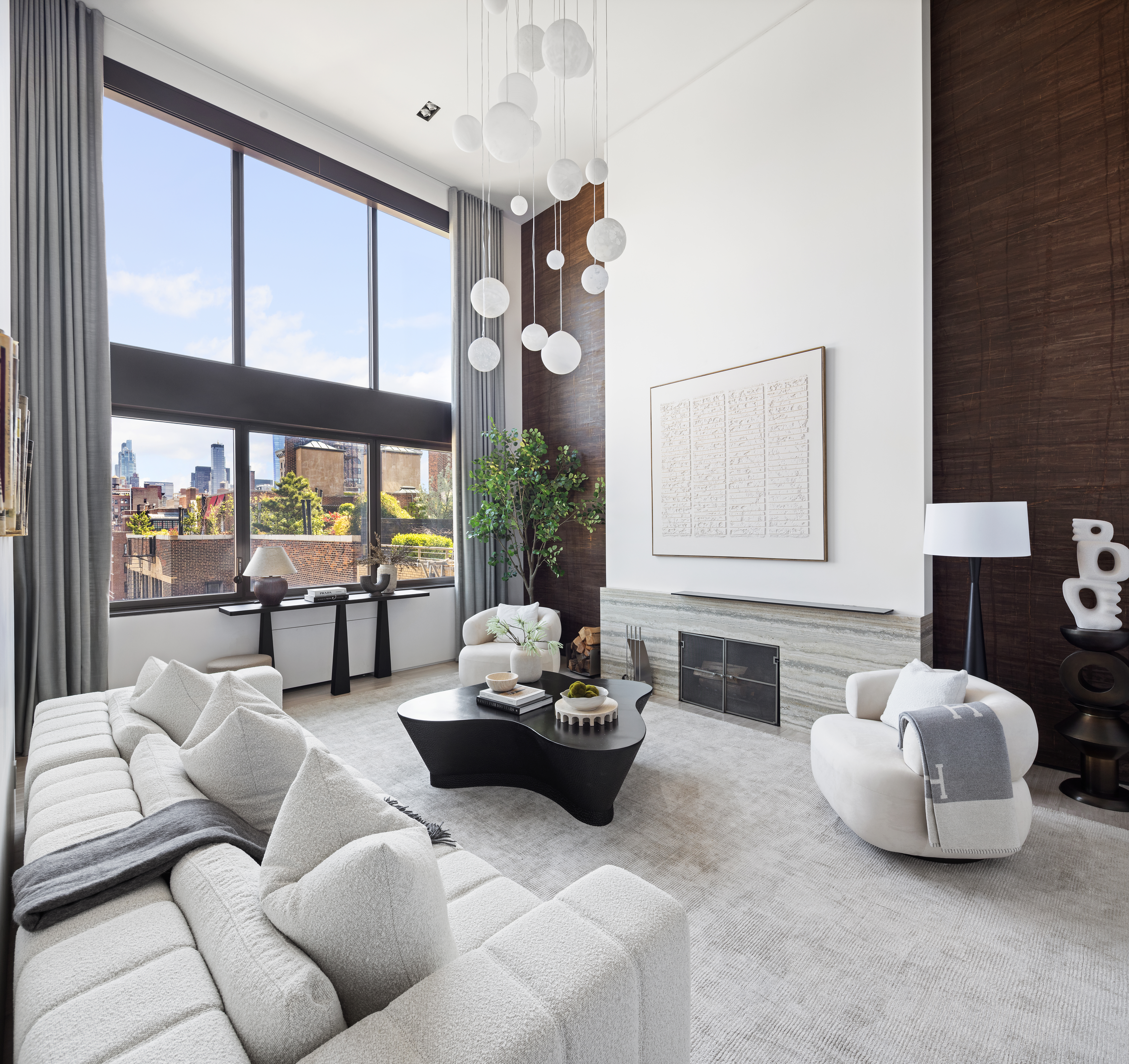24 5th Avenue, Unit PH1701 Manhattan, NY 10011 - Photo 3 of 24 a living room with furniture and a large window