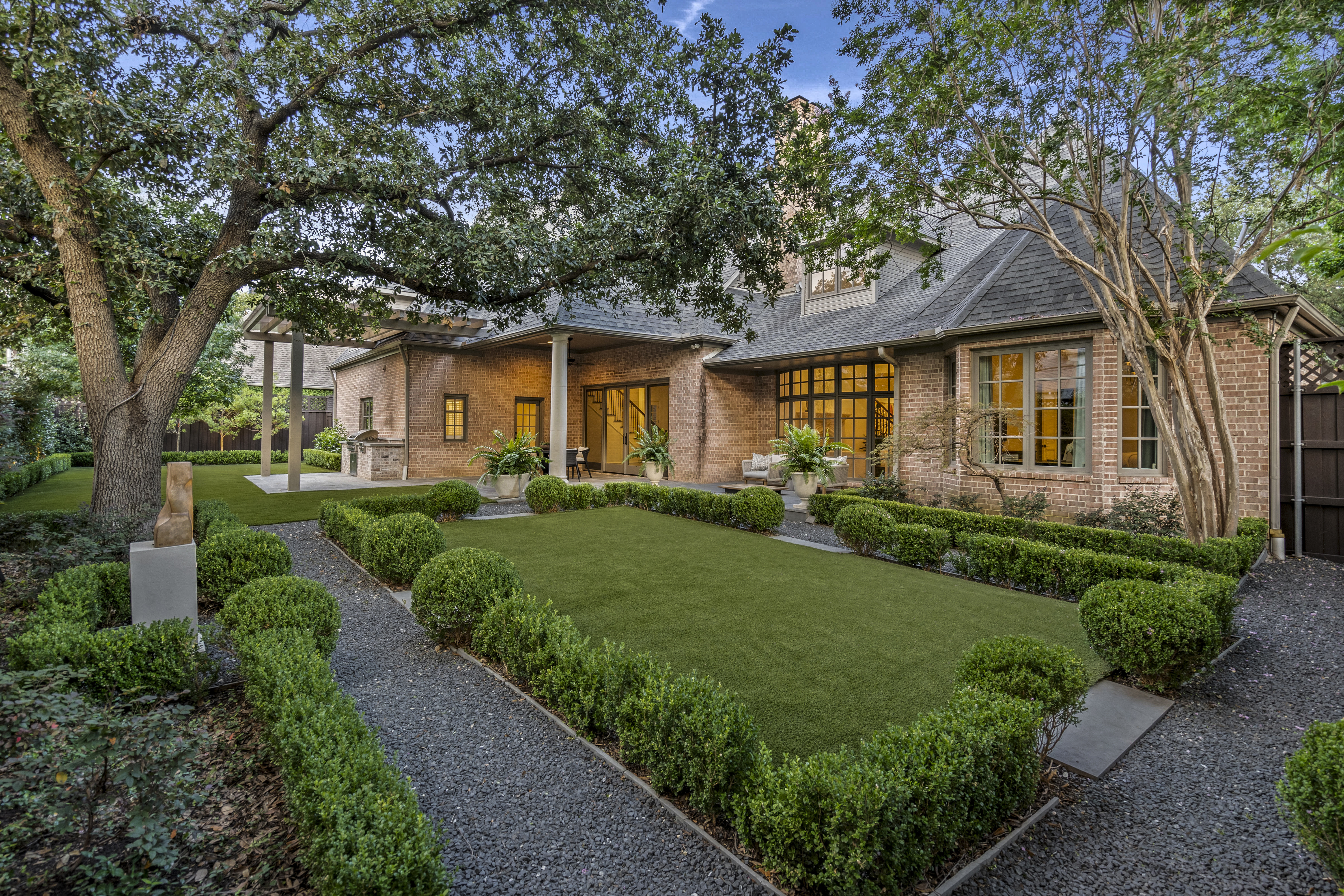 6607 Meadow Road Dallas, TX 75230 - Photo 31 of 32 a front view of a house with a yard and trees