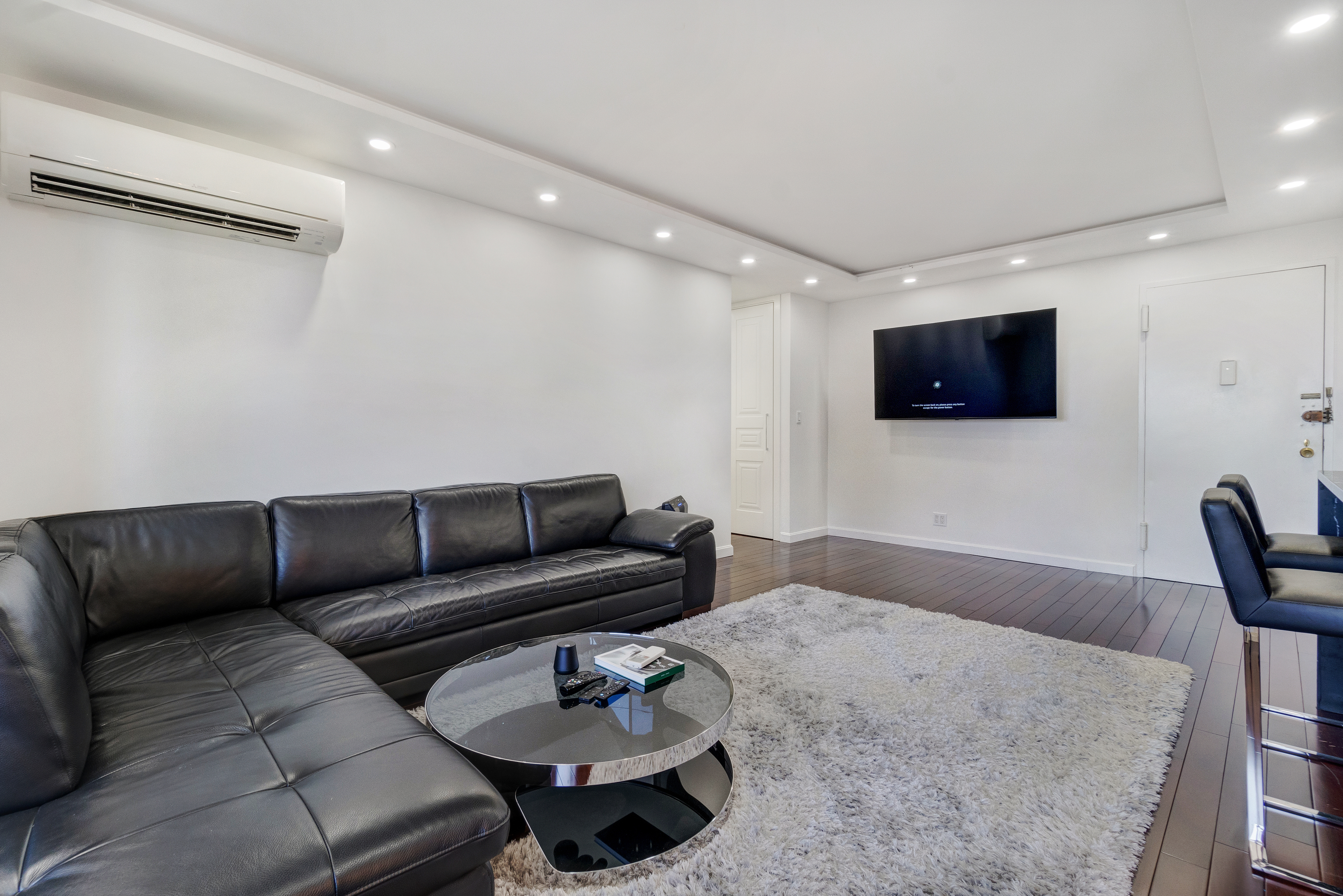 448 Neptune Avenue, Unit 14L Brooklyn, NY 11224 - Photo 6 of 20 a living room with furniture and a flat screen tv