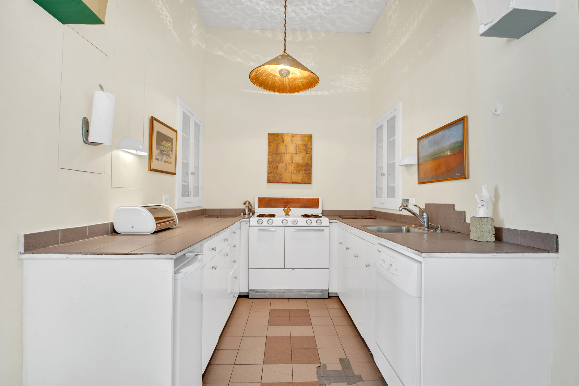 69 Wooster Street, Unit 3 Manhattan, NY 10012 - Photo 8 of 22 a large white kitchen with a sink and dishwasher