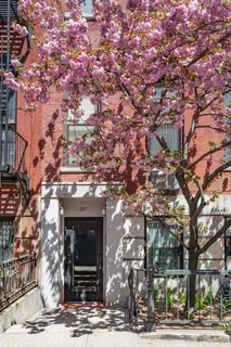a front view of a building with tree s
