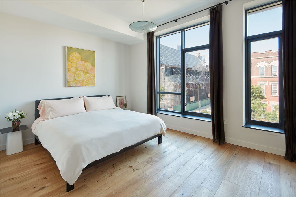 27 Clermont Avenue Brooklyn, NY 11205 - Photo 10 of 19 a bedroom with a large bed and a large window