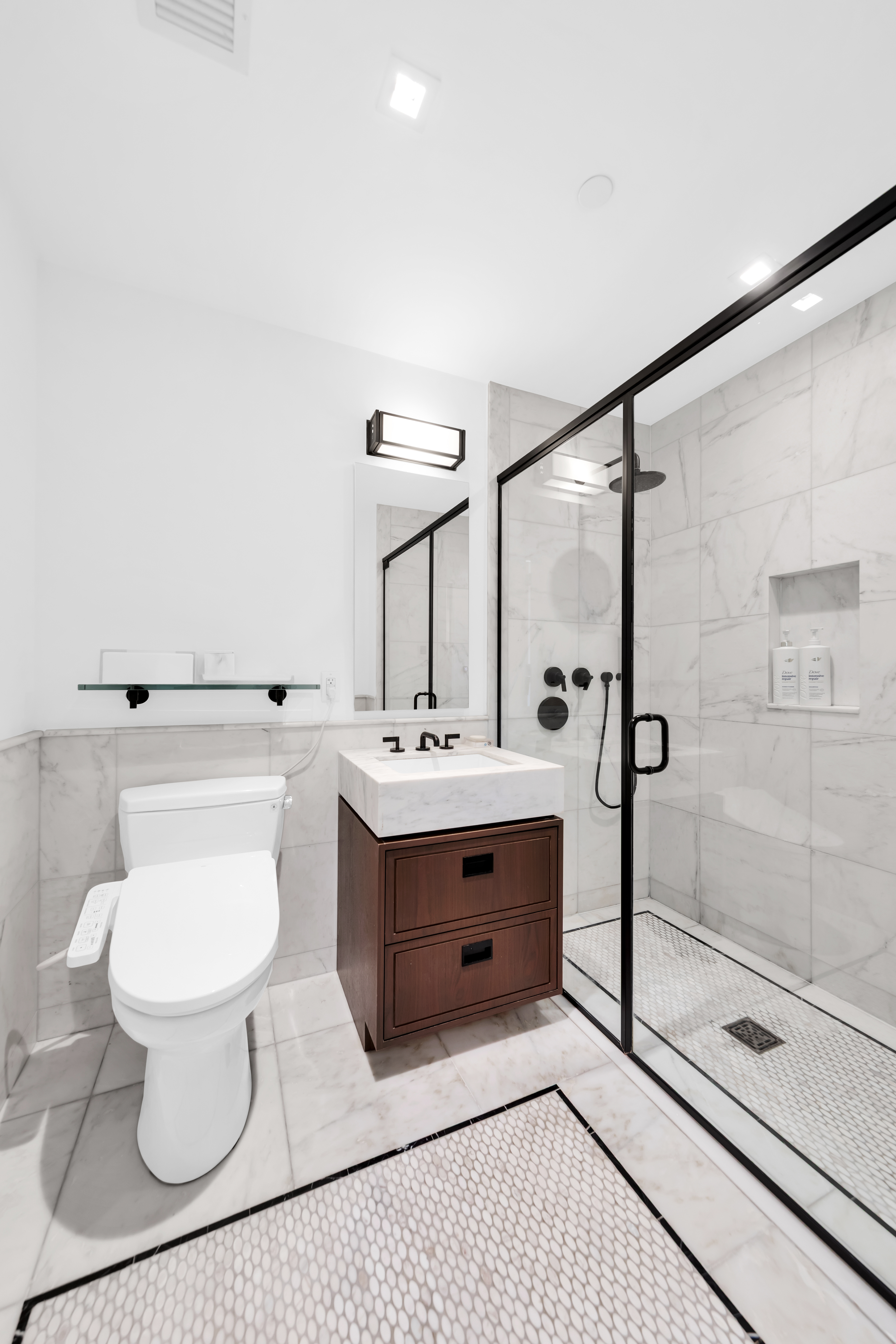 50 West 30th Street, Unit 3B Manhattan, NY 10001 - Photo 4 of 13 a bathroom with a sink toilet a mirror and shower