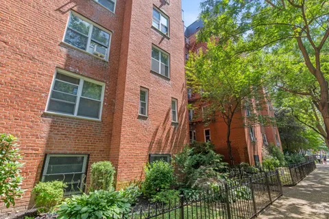a view of a brick building next to a yard