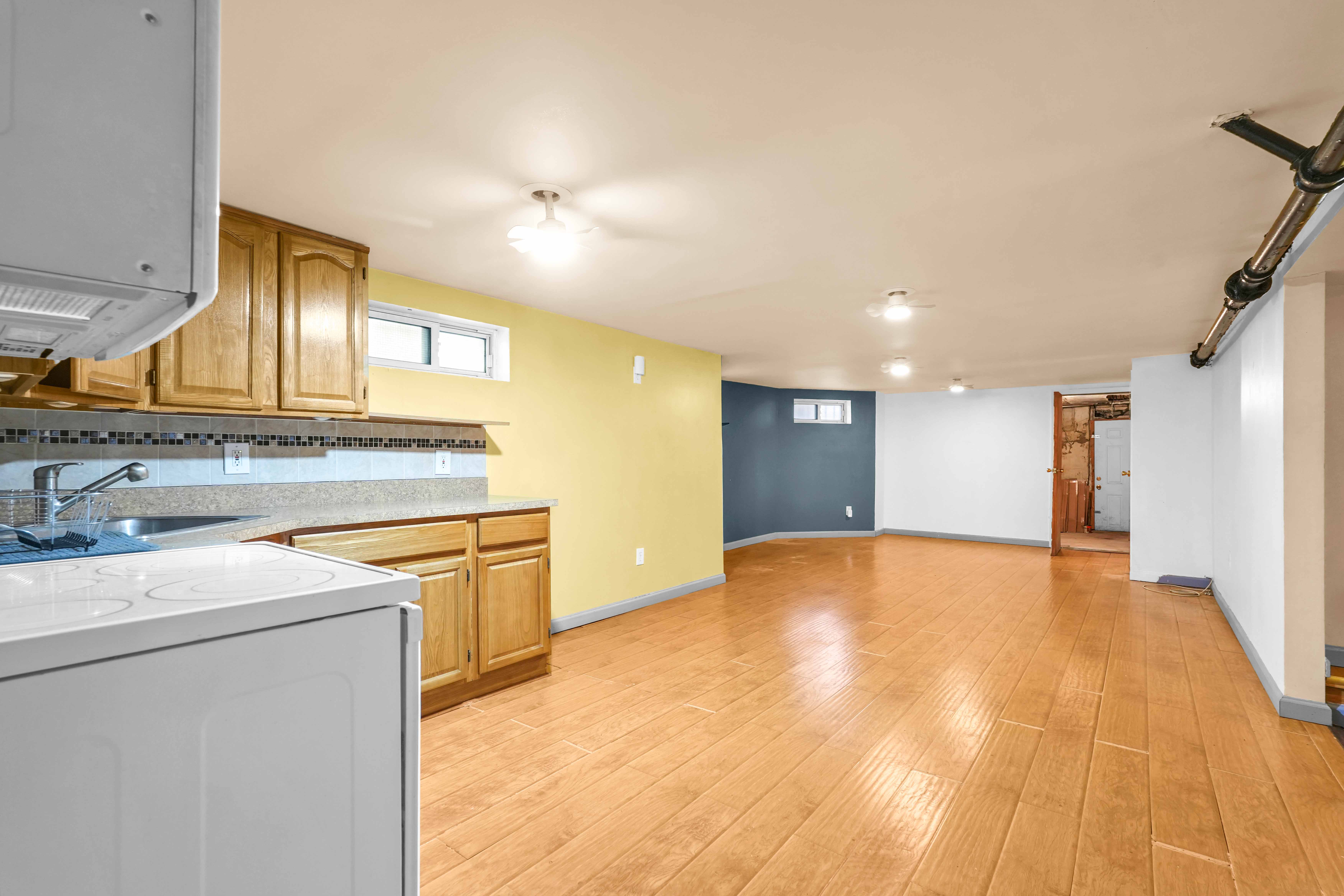 642 East 26th Street Brooklyn, NY 11210 - Photo 26 of 32 a view of a kitchen with a sink and dishwasher a stove top oven with wooden floor