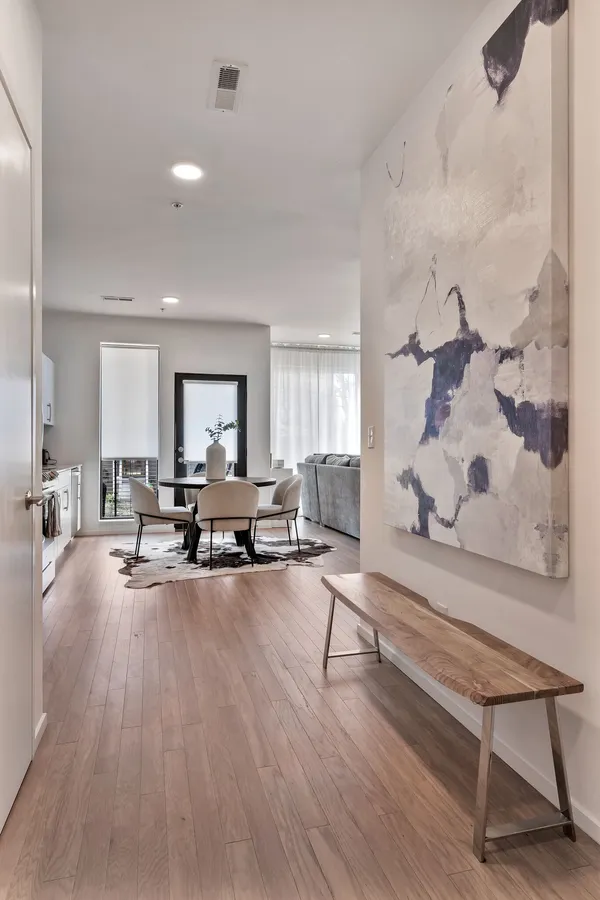 a living room with furniture and wooden floor