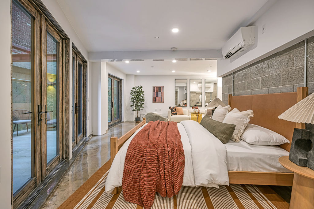 459 Harman Street, Unit 1 Manhattan, NY 10026 - Photo 6 of 17 a spacious bedroom with a bed and a mirror