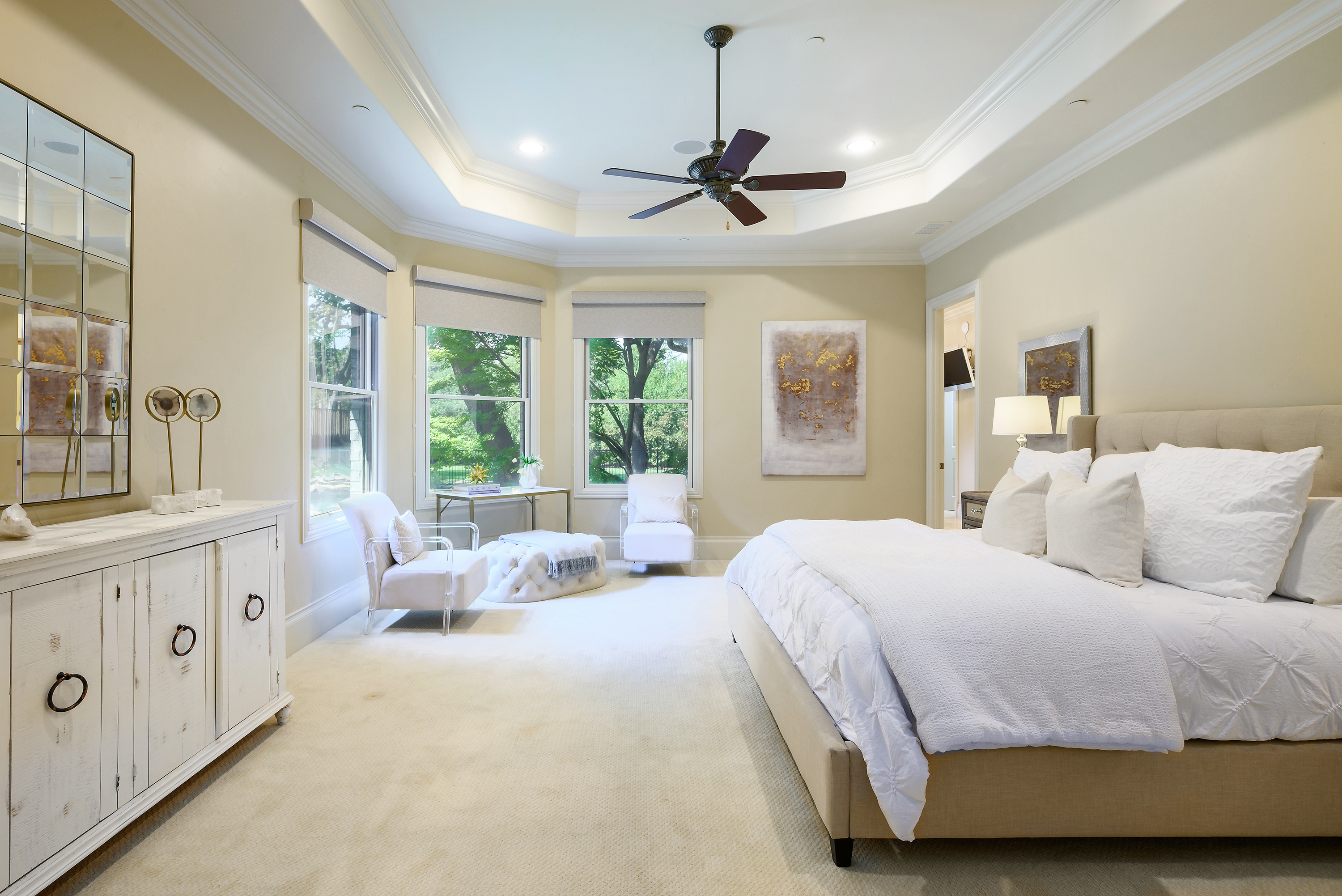 11503 West Ricks Circle Dallas, TX 75230 - Photo 21 of 39 a bedroom with a large bed and a chandelier fan