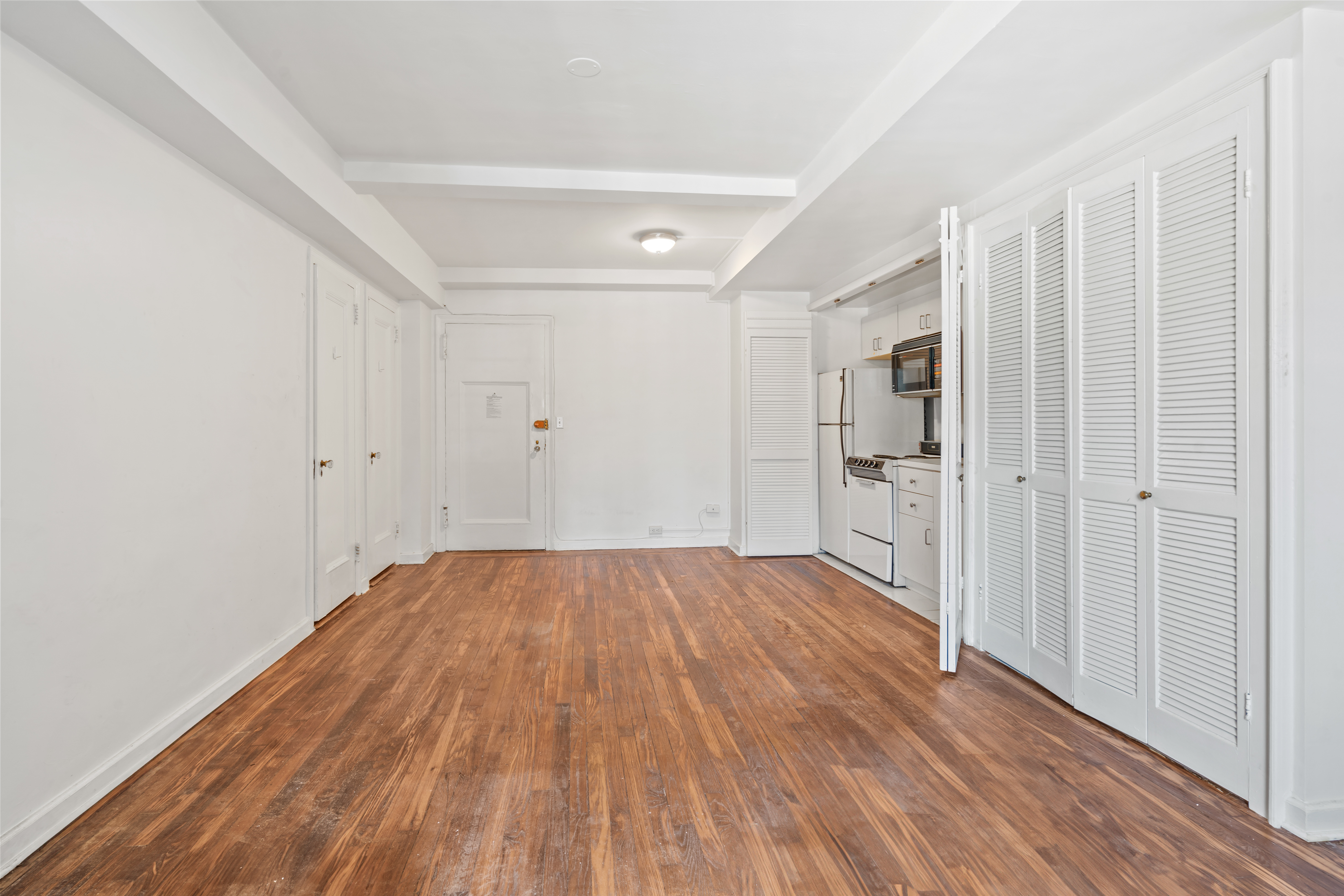 45 Tudor City Place, Unit 1708 Manhattan, NY 10017 - Photo 5 of 14 a view of a room with wooden floor