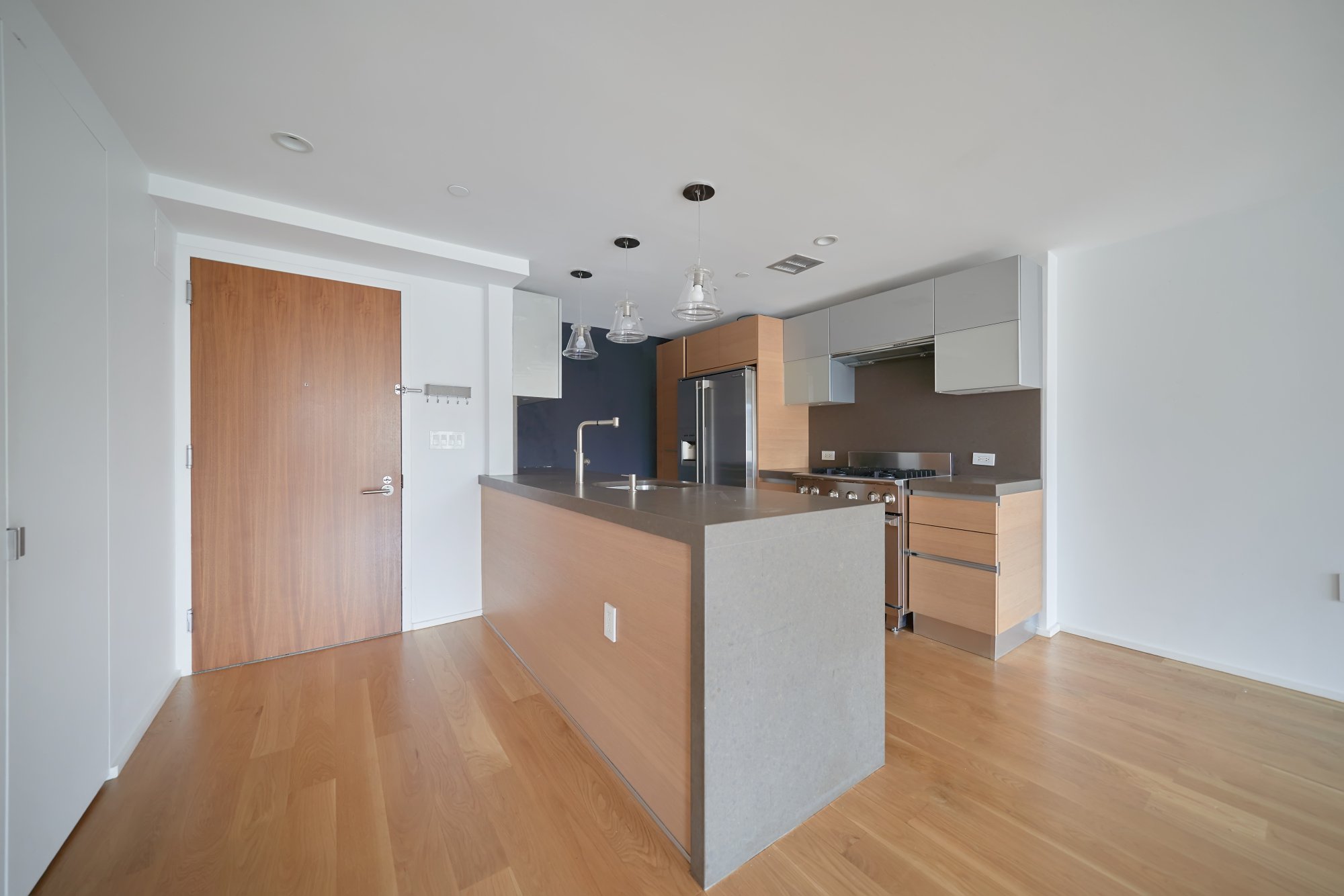 a kitchen with stainless steel appliances a refrigerator and a stove top oven