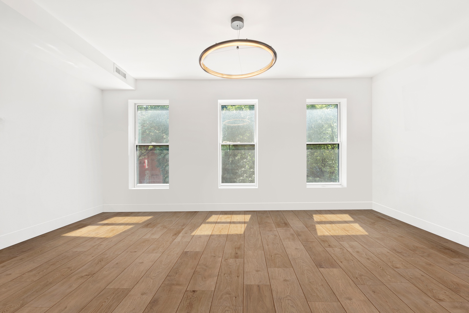 65 Bainbridge Street Brooklyn, NY 11233 - Photo 11 of 24 an empty room with wooden floor and windows