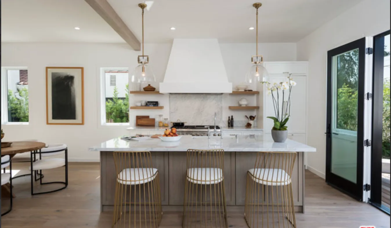 a kitchen with stainless steel appliances granite countertop a sink a stove a refrigerator and island