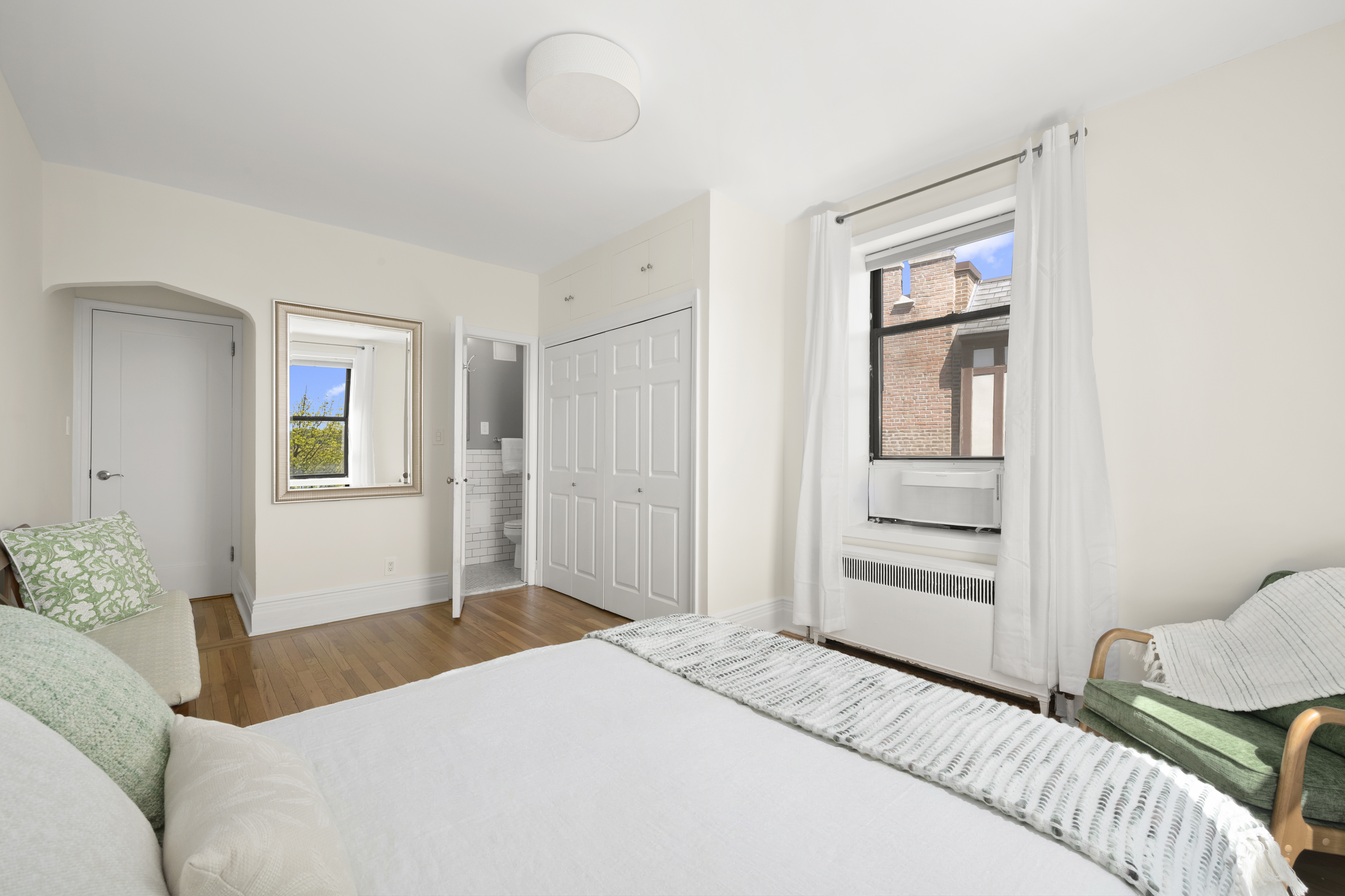 3875 Waldo Avenue, Unit 6E Bronx, NY 10463 - Photo 5 of 11 a bedroom with a bed and a window