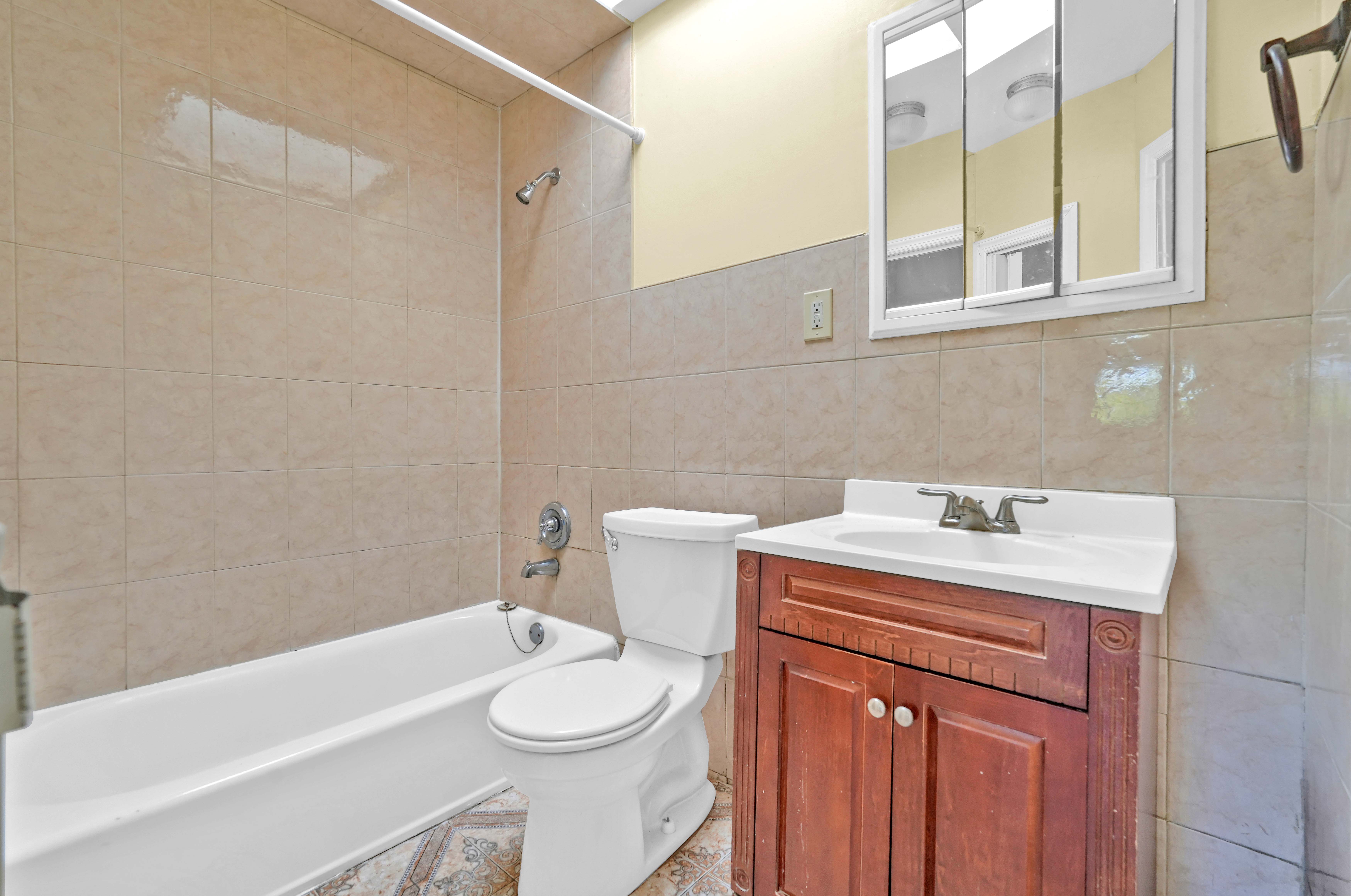 659 Jerome Street Brooklyn, NY 11207 - Photo 22 of 39 a bathroom with a sink a toilet and bathtub