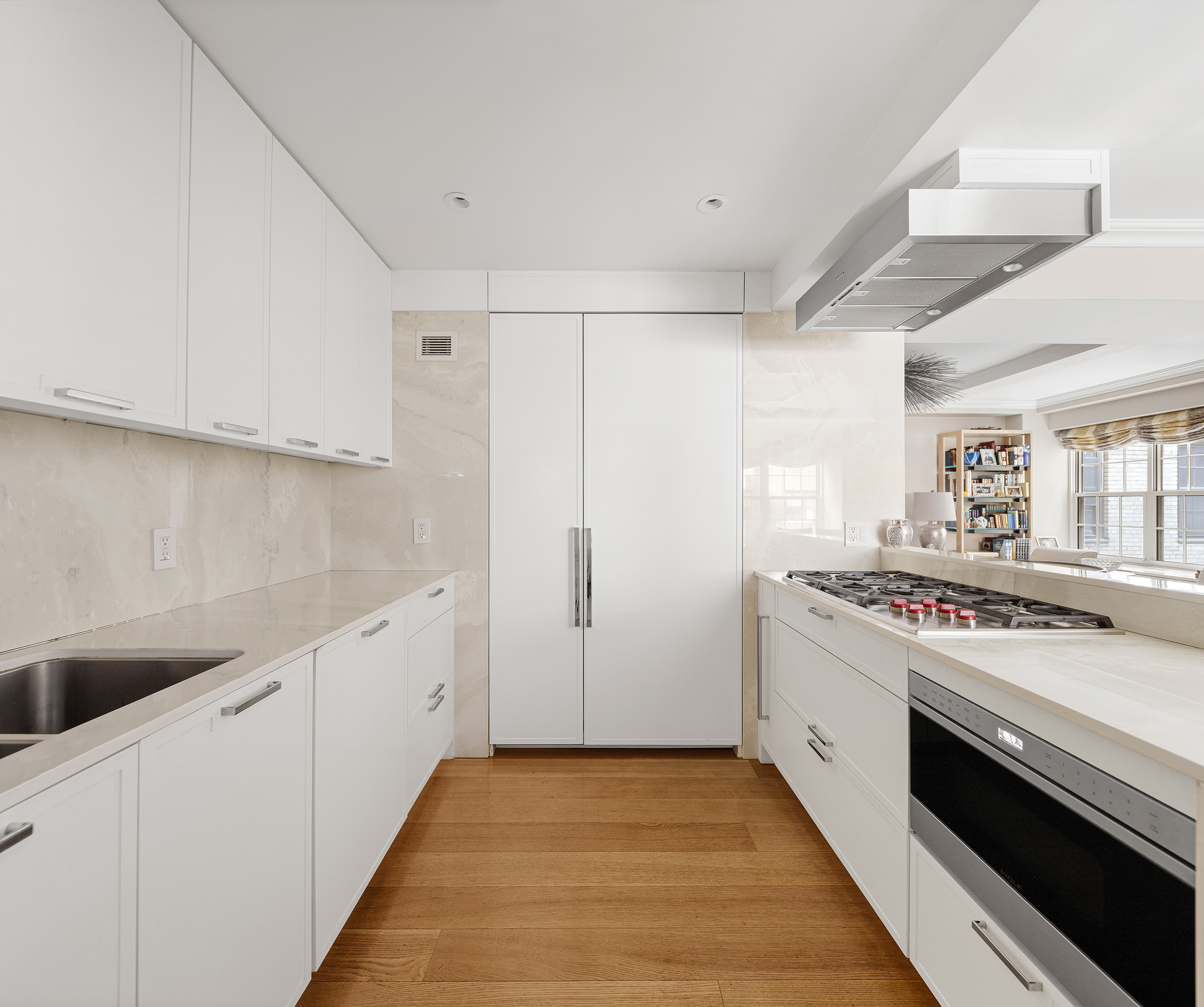 12 East 88th Street, Unit 2D Manhattan, NY 10128 - Photo 3 of 15 a kitchen with white cabinets and white appliances