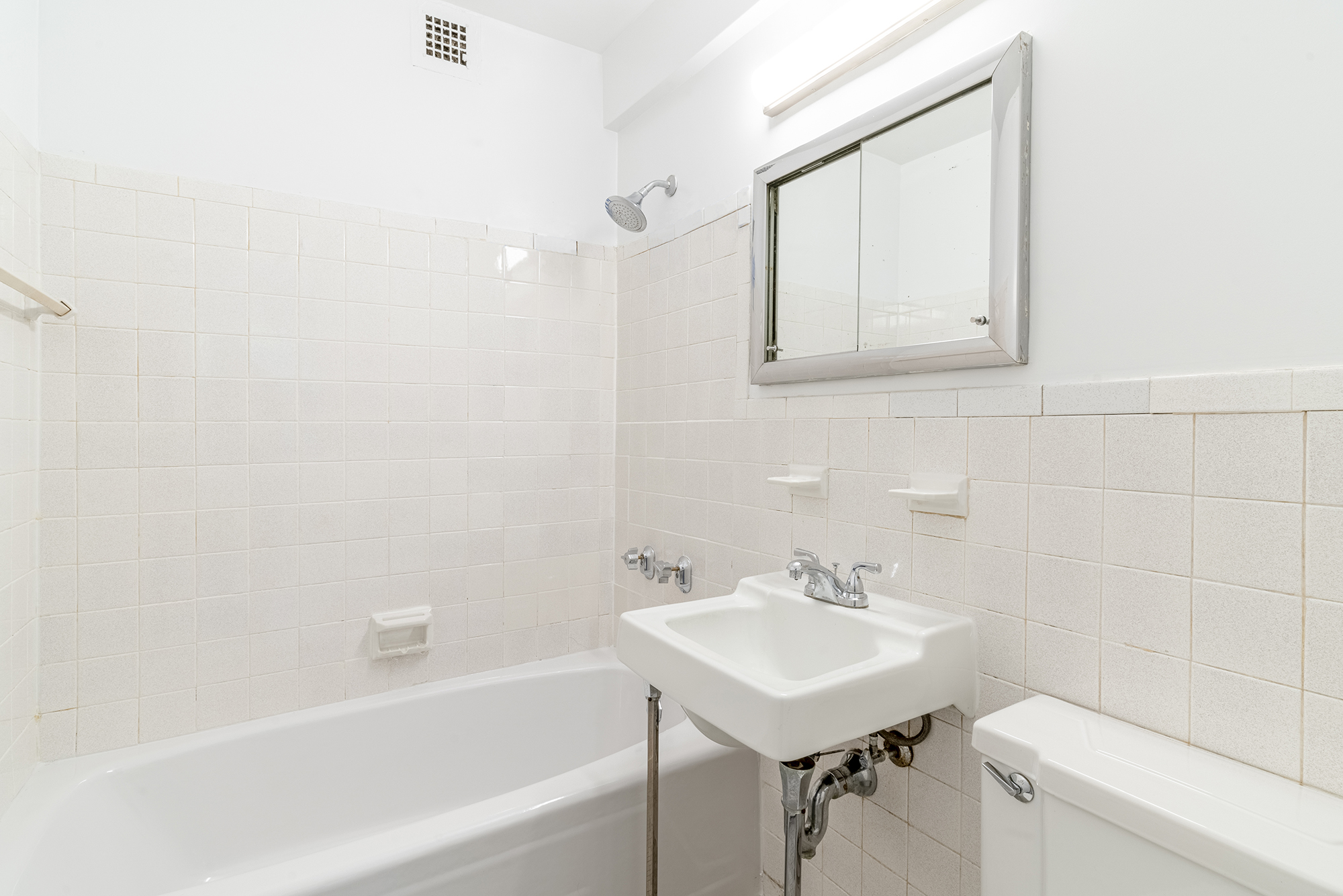 155 East 34th Street, Unit 3B Manhattan, NY 10016 - Photo 5 of 11 a bathroom with a sink a toilet and shower