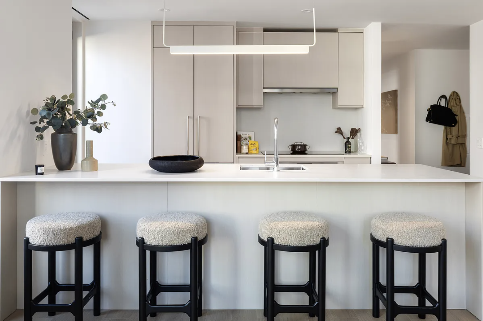 300 East 50th Street, Unit 18A Manhattan, NY 10022 - Photo 12 of 27 a kitchen with stainless steel appliances a table and chairs in it
