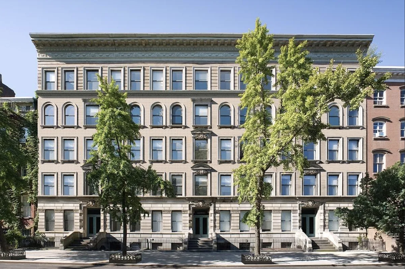422 West 20th Street, Unit PARLOR H Manhattan, NY 10011 - Photo 13 of 16 a front view of a residential apartment building with a yard