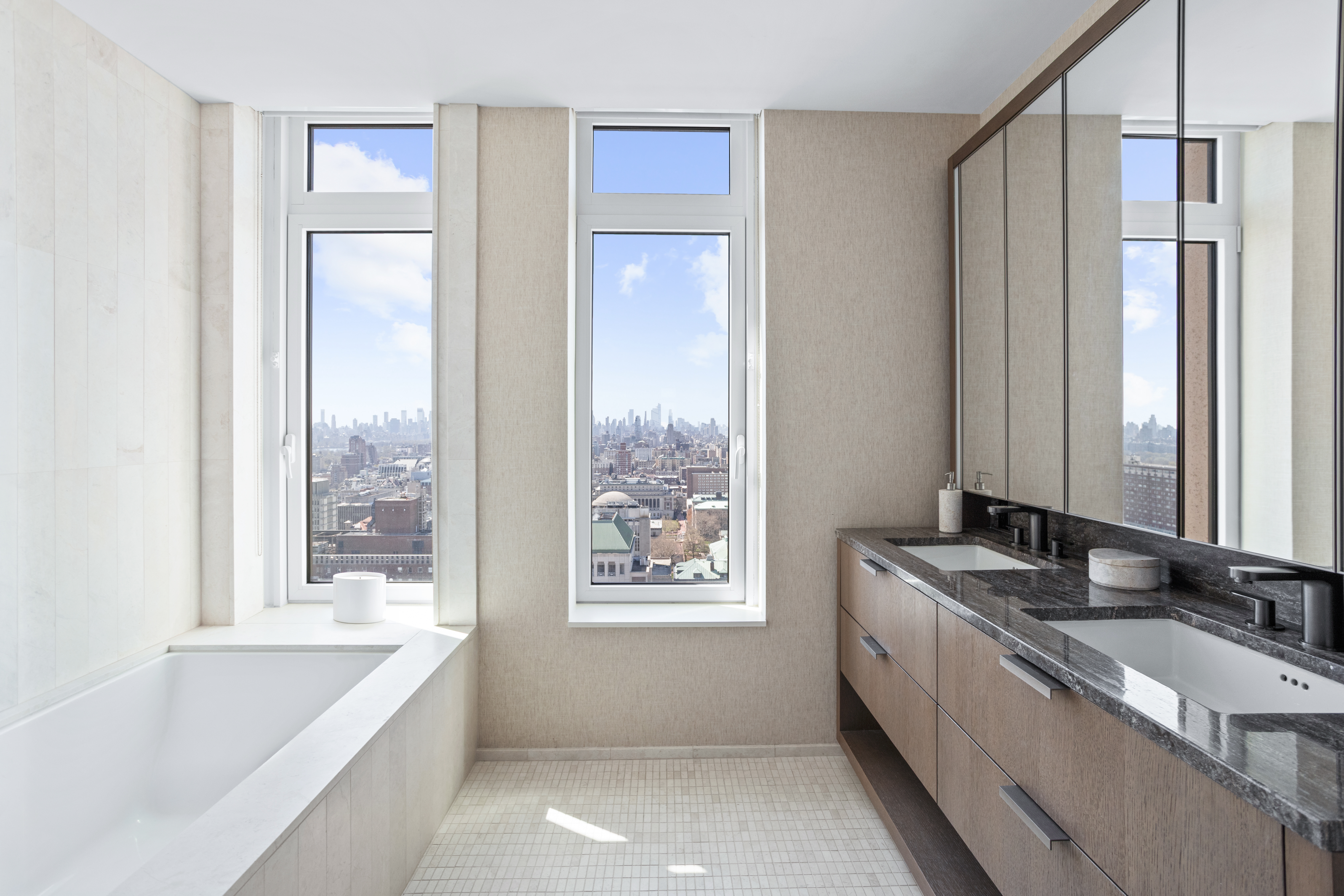 543 West 122nd Street, Unit PH31A Manhattan, NY 10027 - Photo 22 of 40 a bathroom with a granite countertop tub sink and mirror