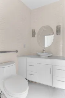 a bathroom with a toilet a sink and mirror
