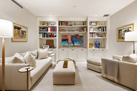 a living room with furniture cabinets and window
