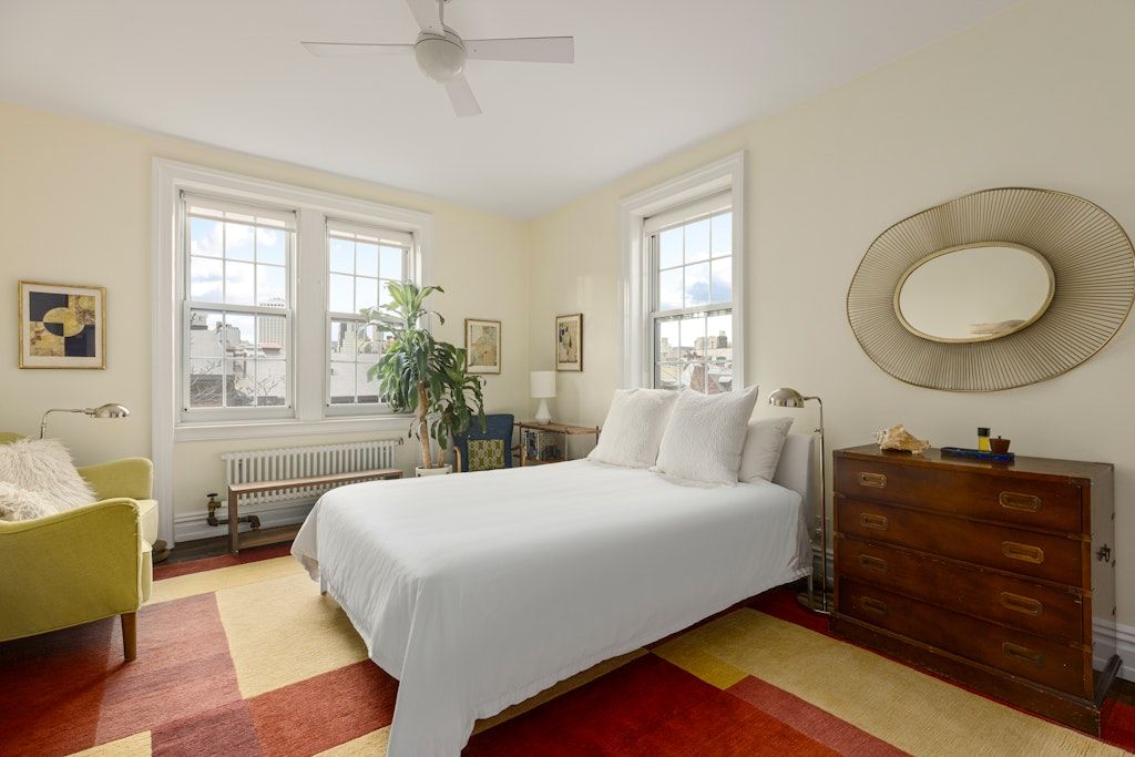 a bedroom with a bed and window