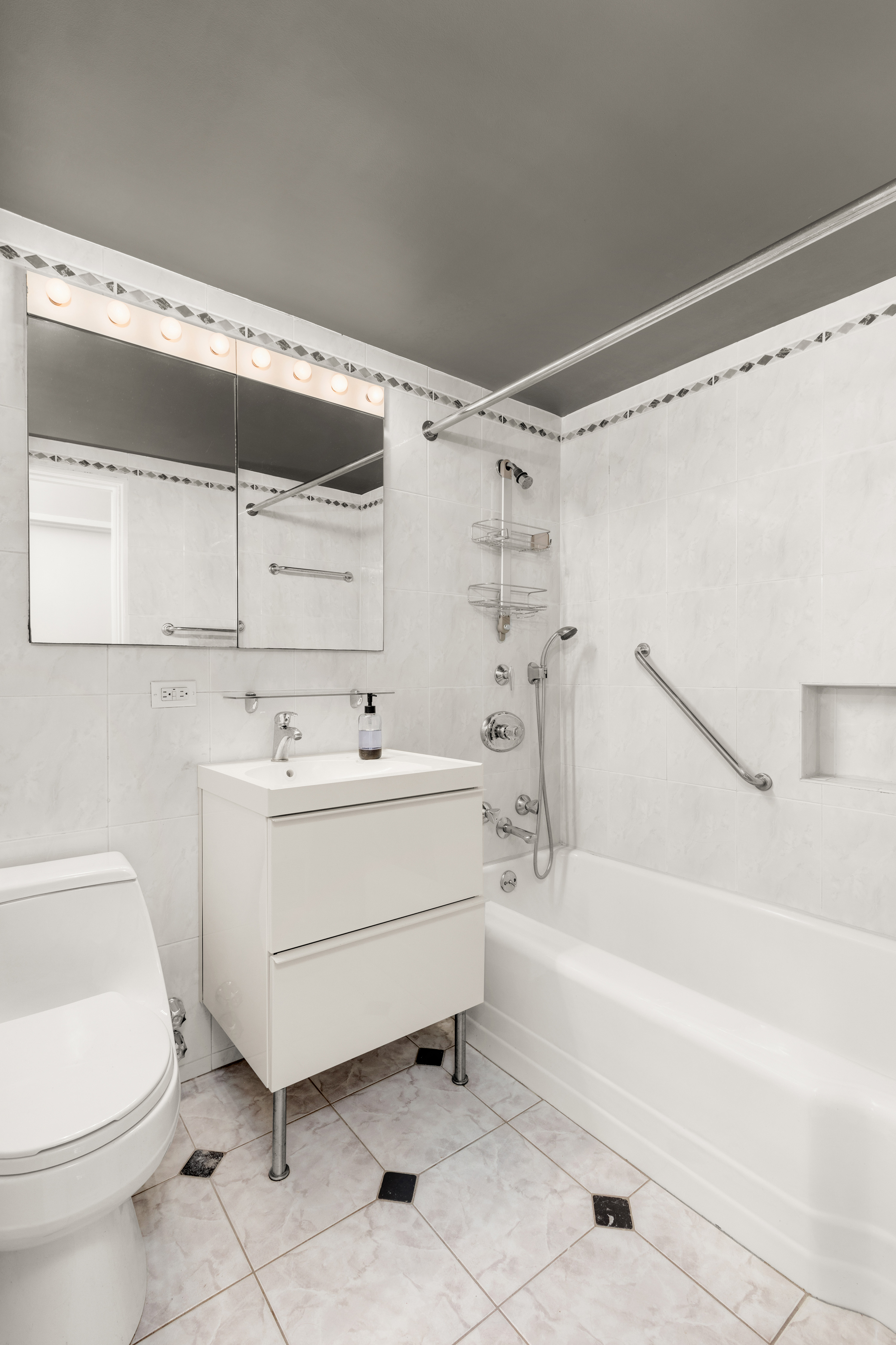 525 East 86th Street, Unit 2G Manhattan, NY 10028 - Photo 8 of 12 a bathroom with a sink toilet and shower