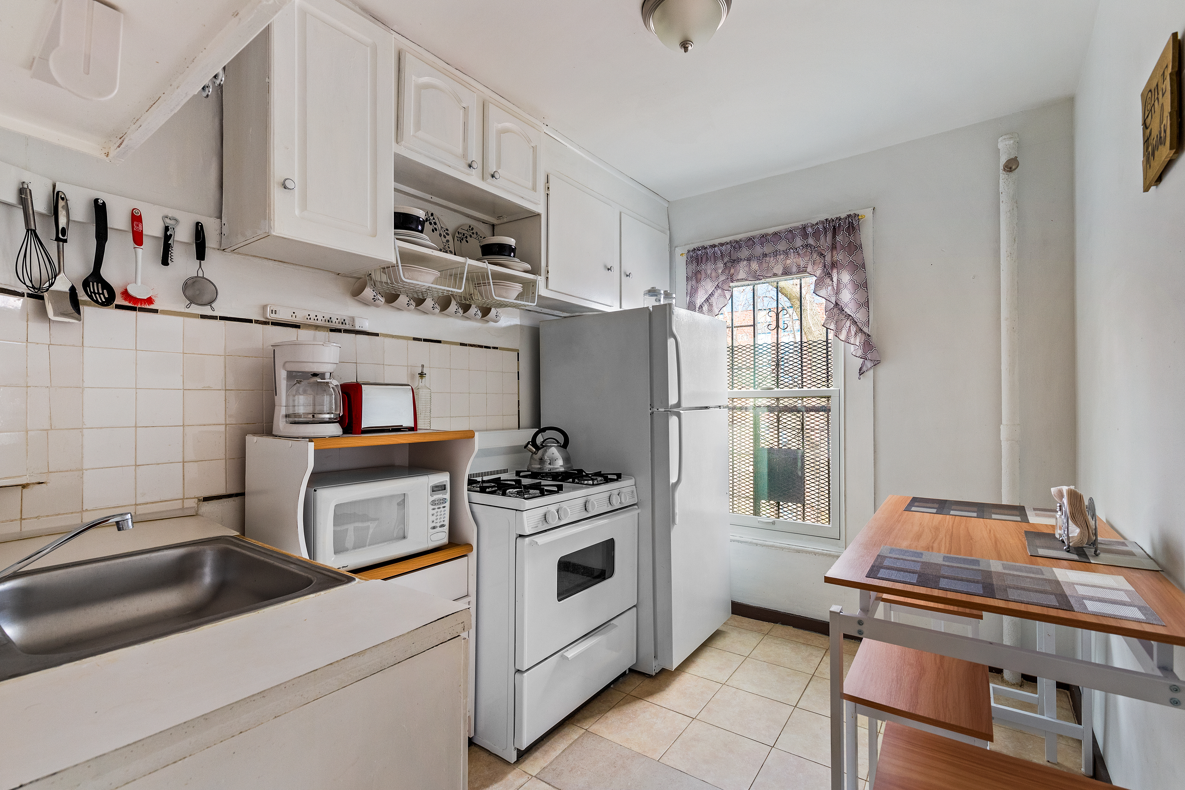 415 Monroe Street Brooklyn, NY 11221 - Photo 8 of 9 a kitchen with stainless steel appliances granite countertop a stove and a refrigerator