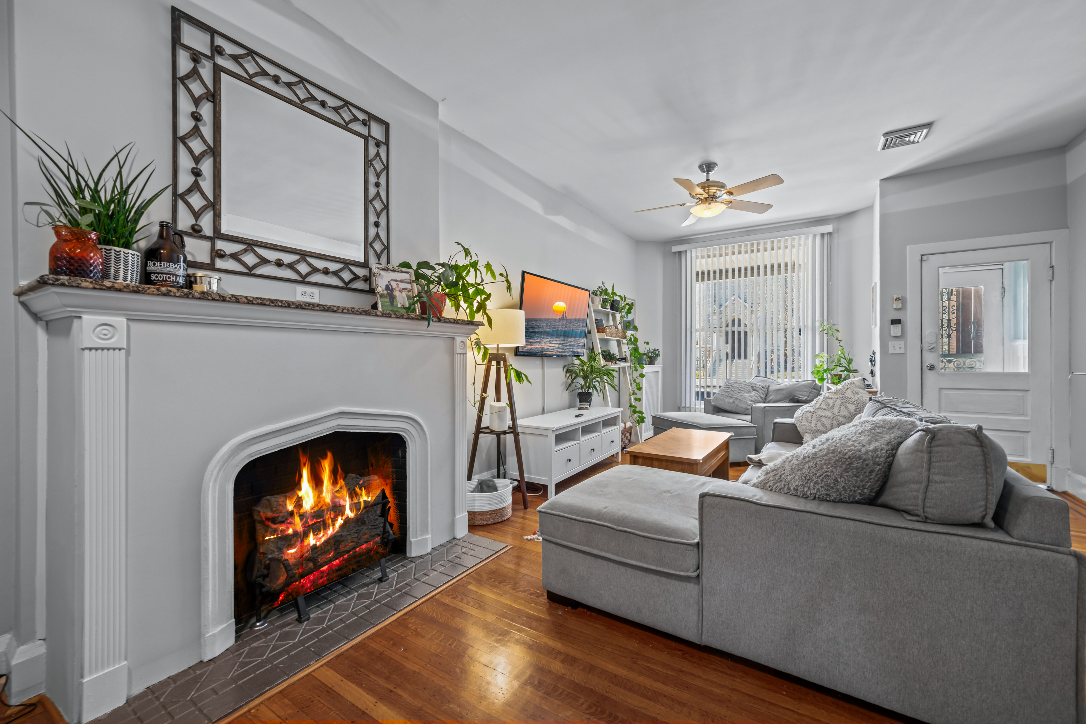 633 South Conkling Street Baltimore, MD 21224 - Photo 7 of 23 a living room with furniture a fireplace and a flat screen tv