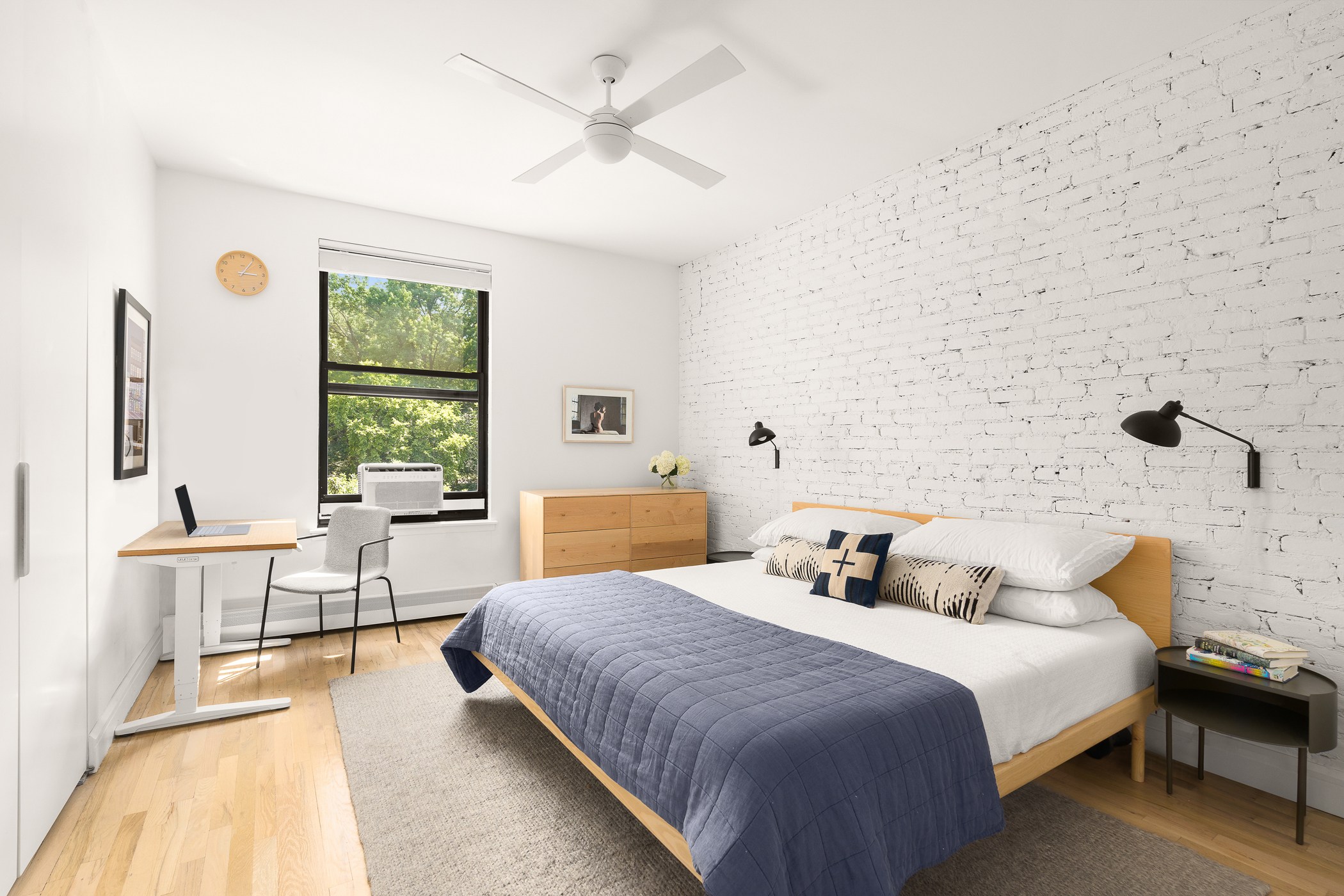 115 Eastern Parkway, Unit 3H Brooklyn, NY 11238 - Photo 4 of 12 a bedroom with a large bed and a chandelier