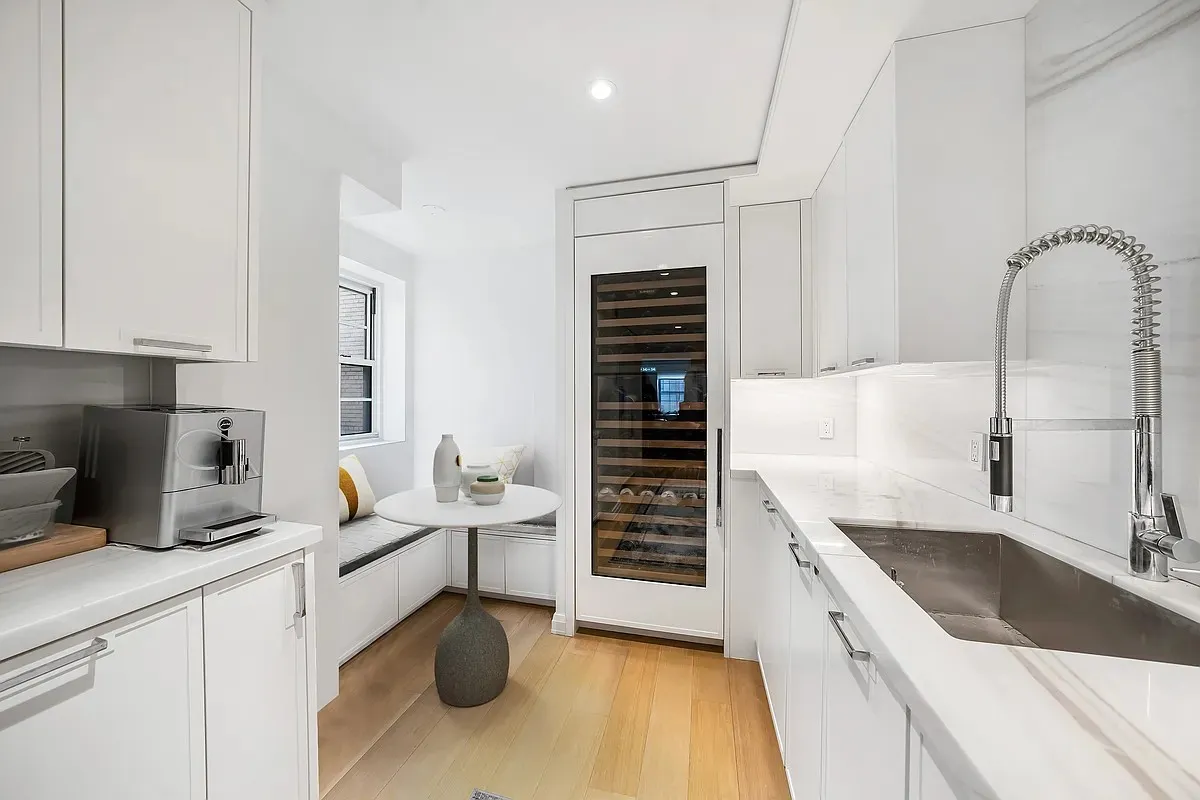 a kitchen with a sink cabinets and appliances