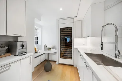 a kitchen with a sink cabinets and appliances