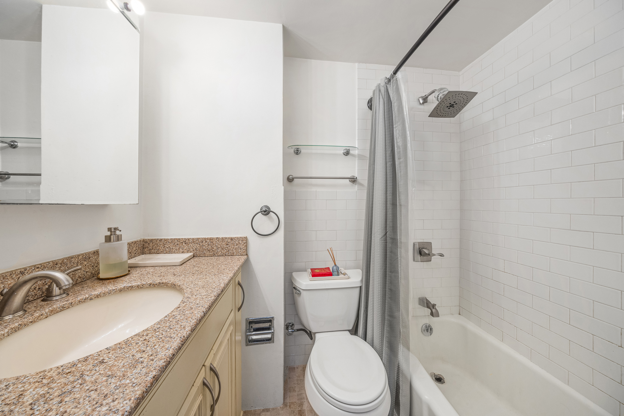 342 West 22nd Street, Unit 3 Manhattan, NY 10011 - Photo 10 of 11 a bathroom with a granite countertop toilet sink and shower