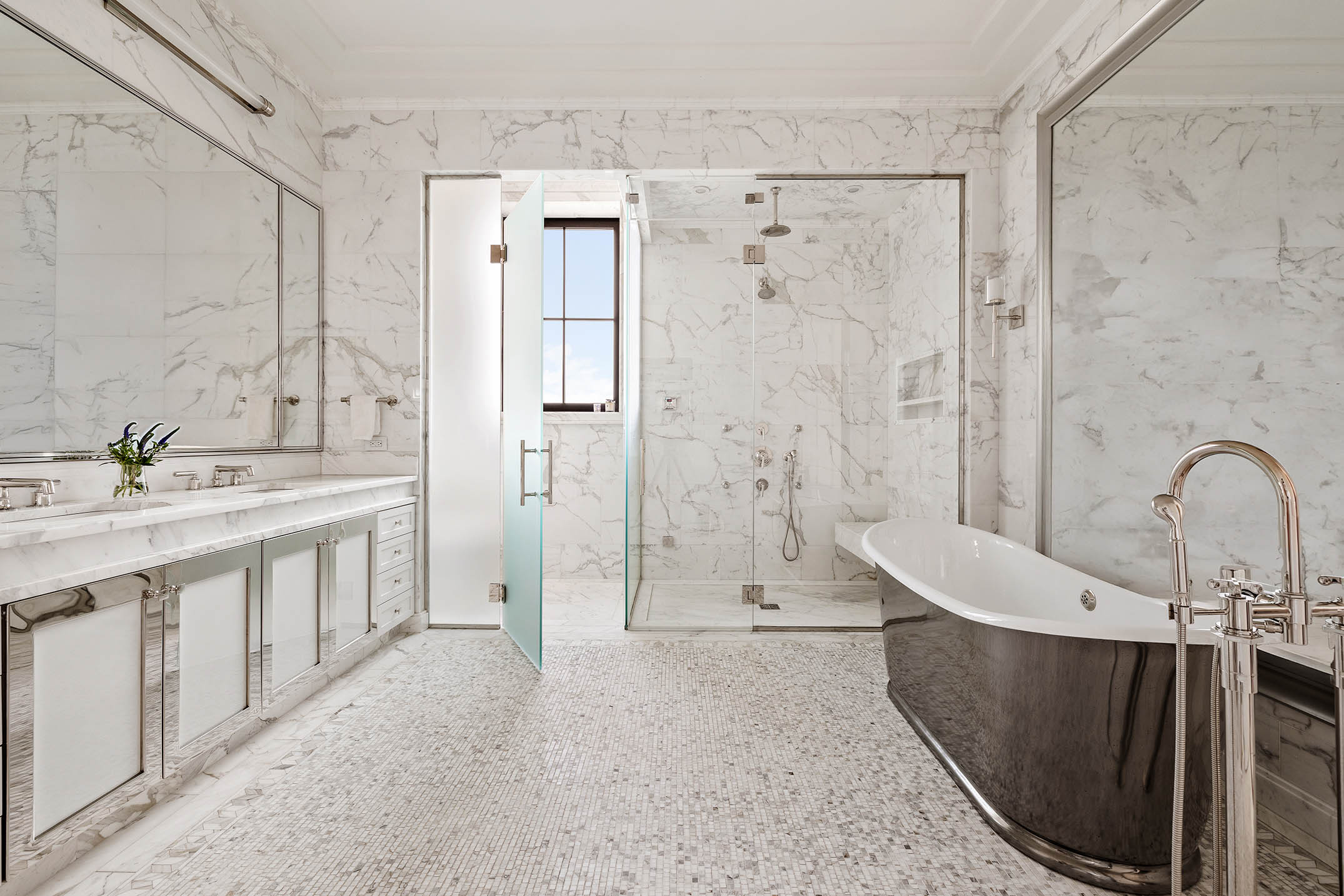 212 West 18th Street, Unit 14A Manhattan, NY 10011 - Photo 11 of 17 a bathroom with a sink a mirror and a bathtub