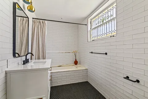 a view of a livingroom with wooden floor and a window