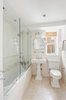 a bathroom with a granite countertop toilet a sink and bathtub