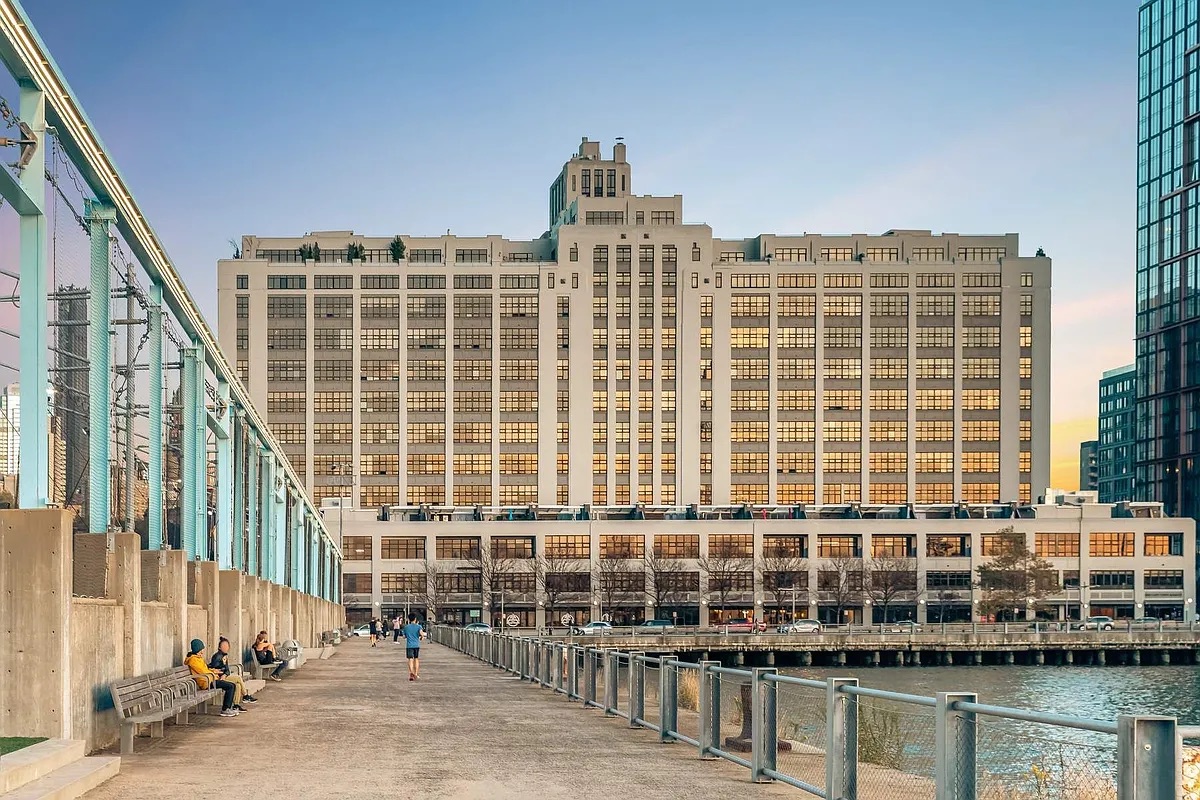 360 Furman Street, Unit 202 Brooklyn, NY 11201 - Photo 17 of 55 a front view of a building with glass windows and a table