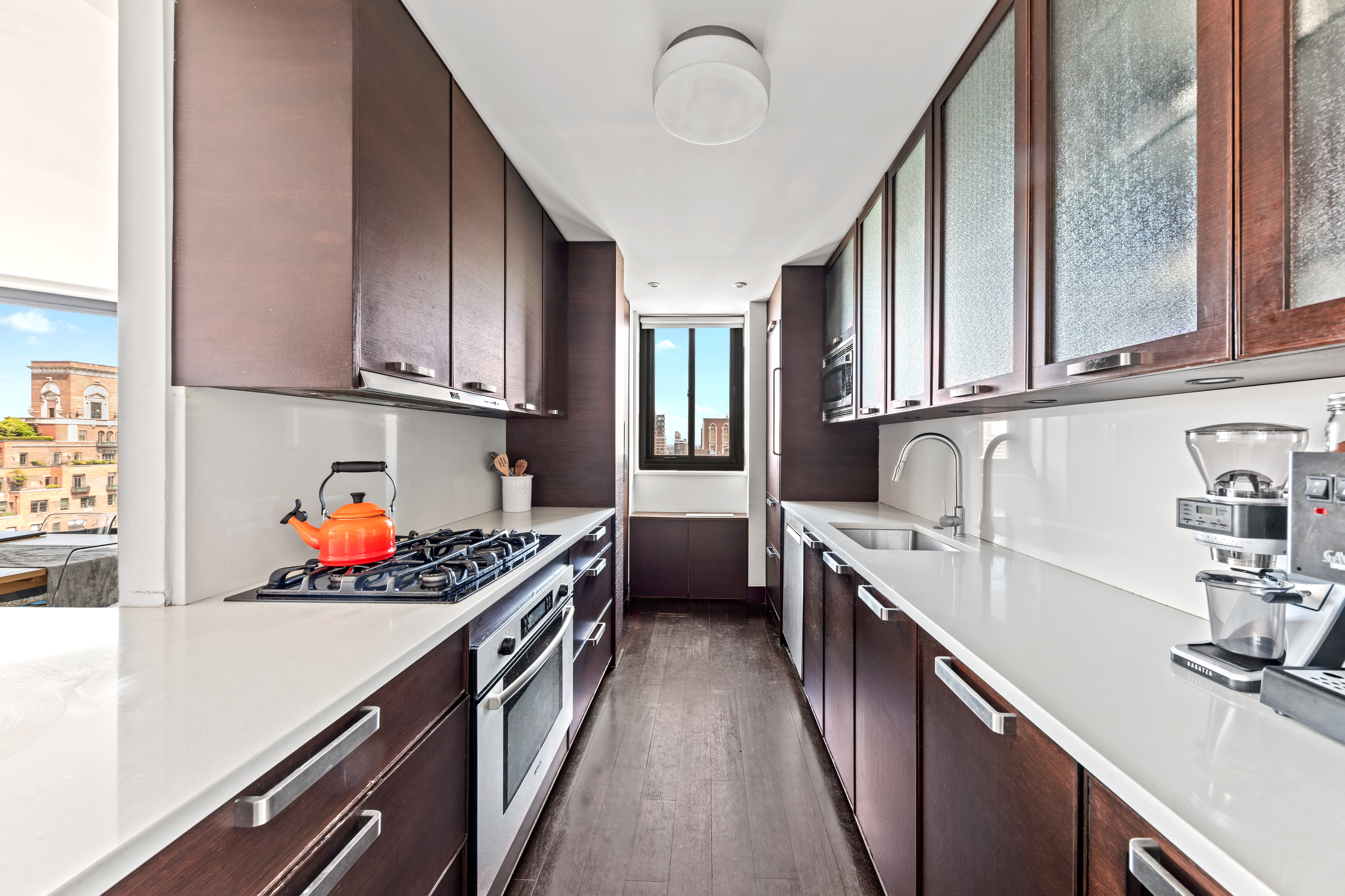 40 East 94th Street, Unit 21F Manhattan, NY 10128 - Photo 2 of 8 a kitchen with stainless steel appliances a sink dishwasher stove refrigerator and cabinets