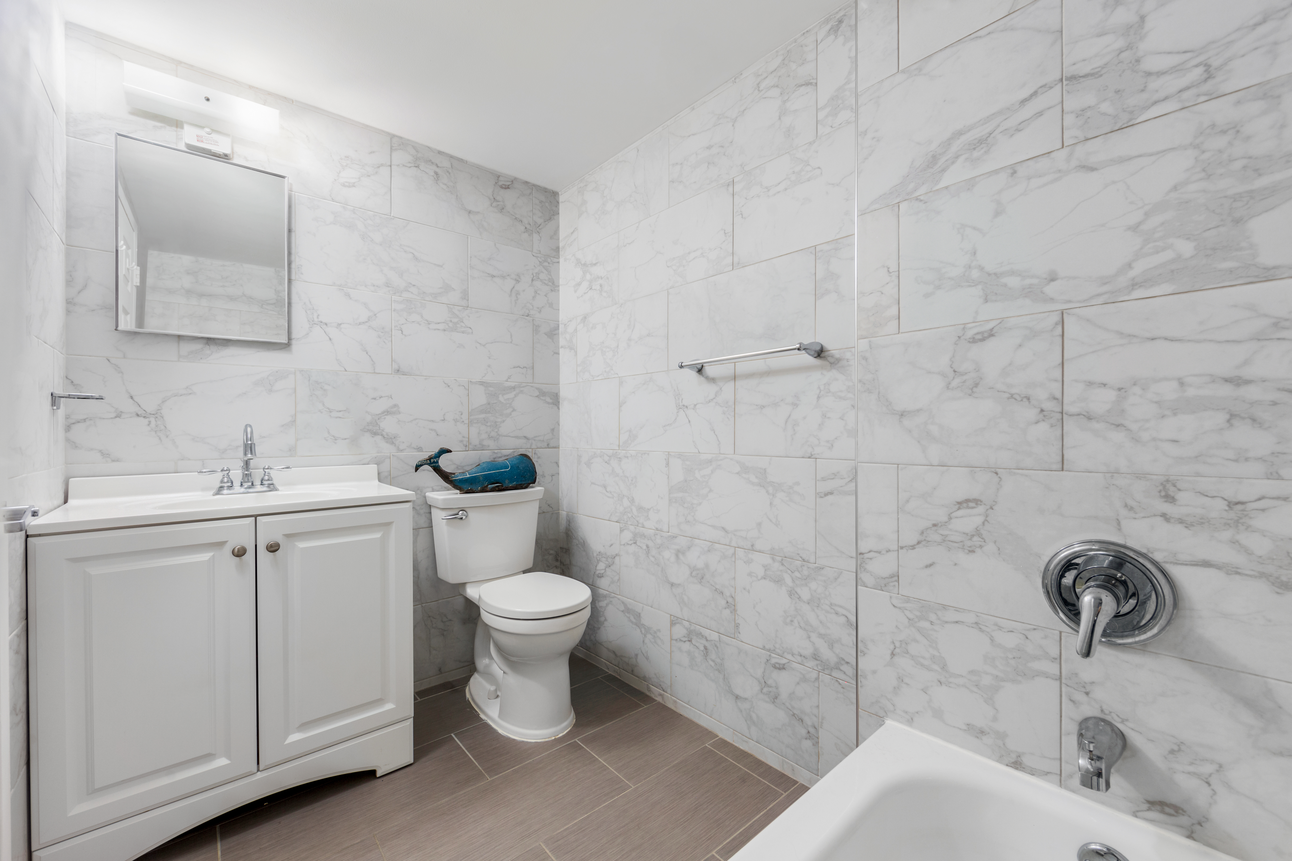 226 West 123rd Street, Unit 2 Manhattan, NY 10027 - Photo 3 of 9 a bathroom with a sink toilet and shower