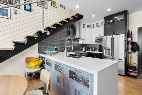 a kitchen with stainless steel appliances a sink a refrigerator and a stove