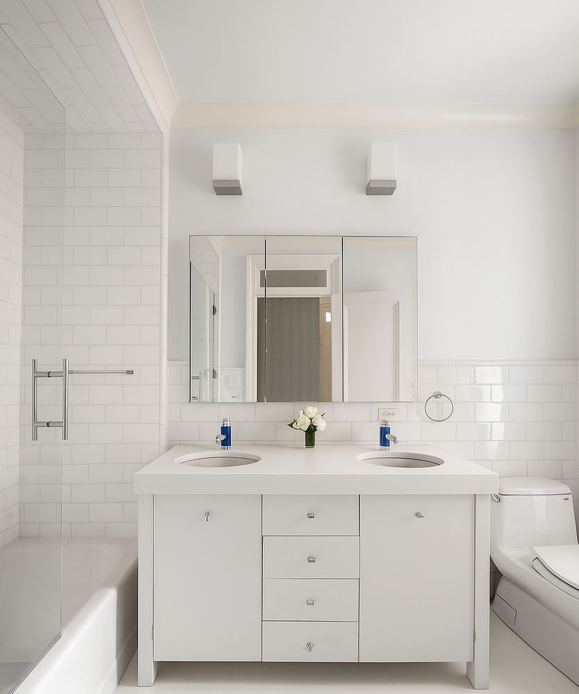 a bathroom with a double vanity sink mirror and