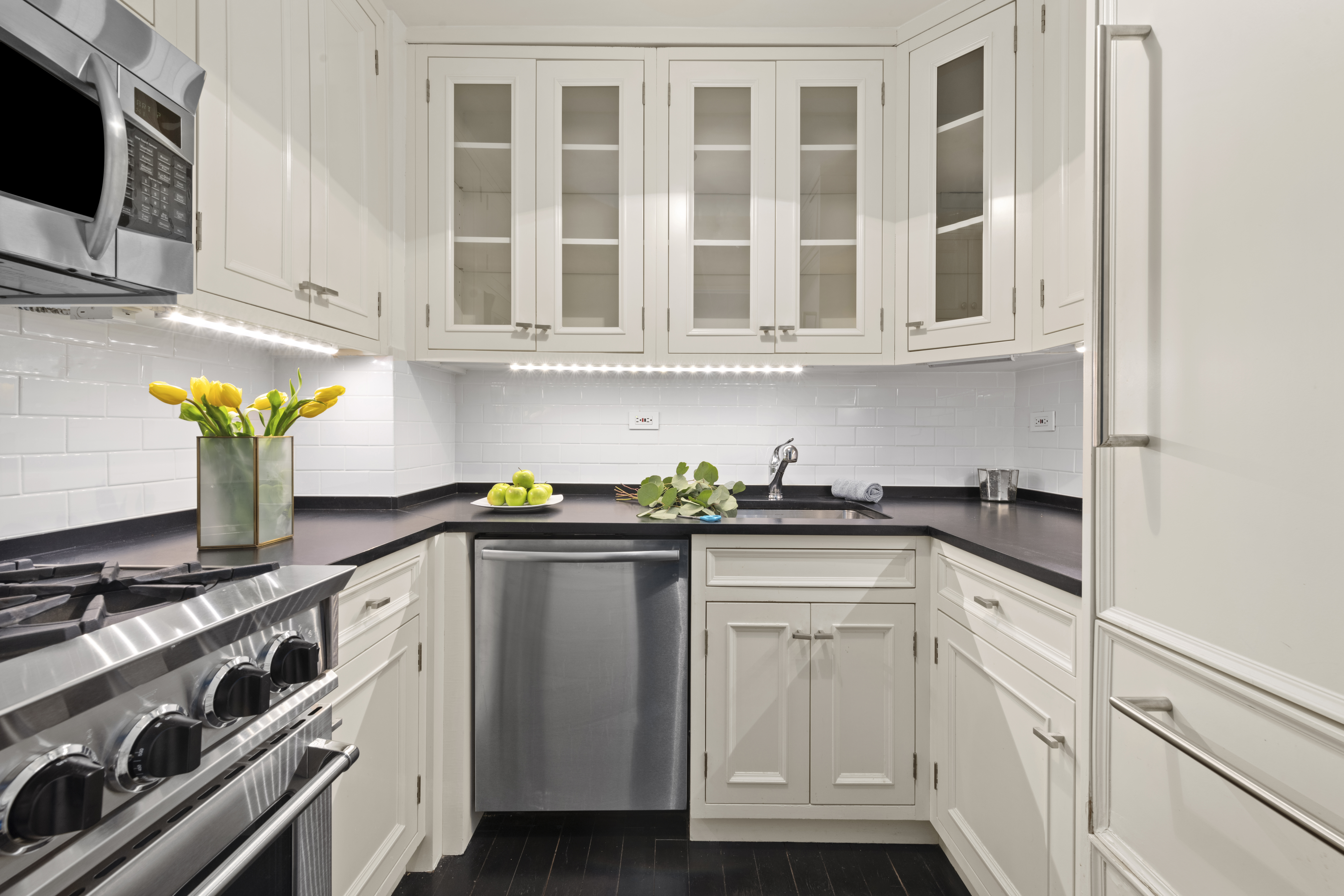 7 East 14th Street, Unit 1229 Manhattan, NY 10003 - Photo 2 of 9 a kitchen with stainless steel appliances granite countertop a sink and a stove