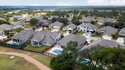 an aerial view of a house with swimming pool and garden view