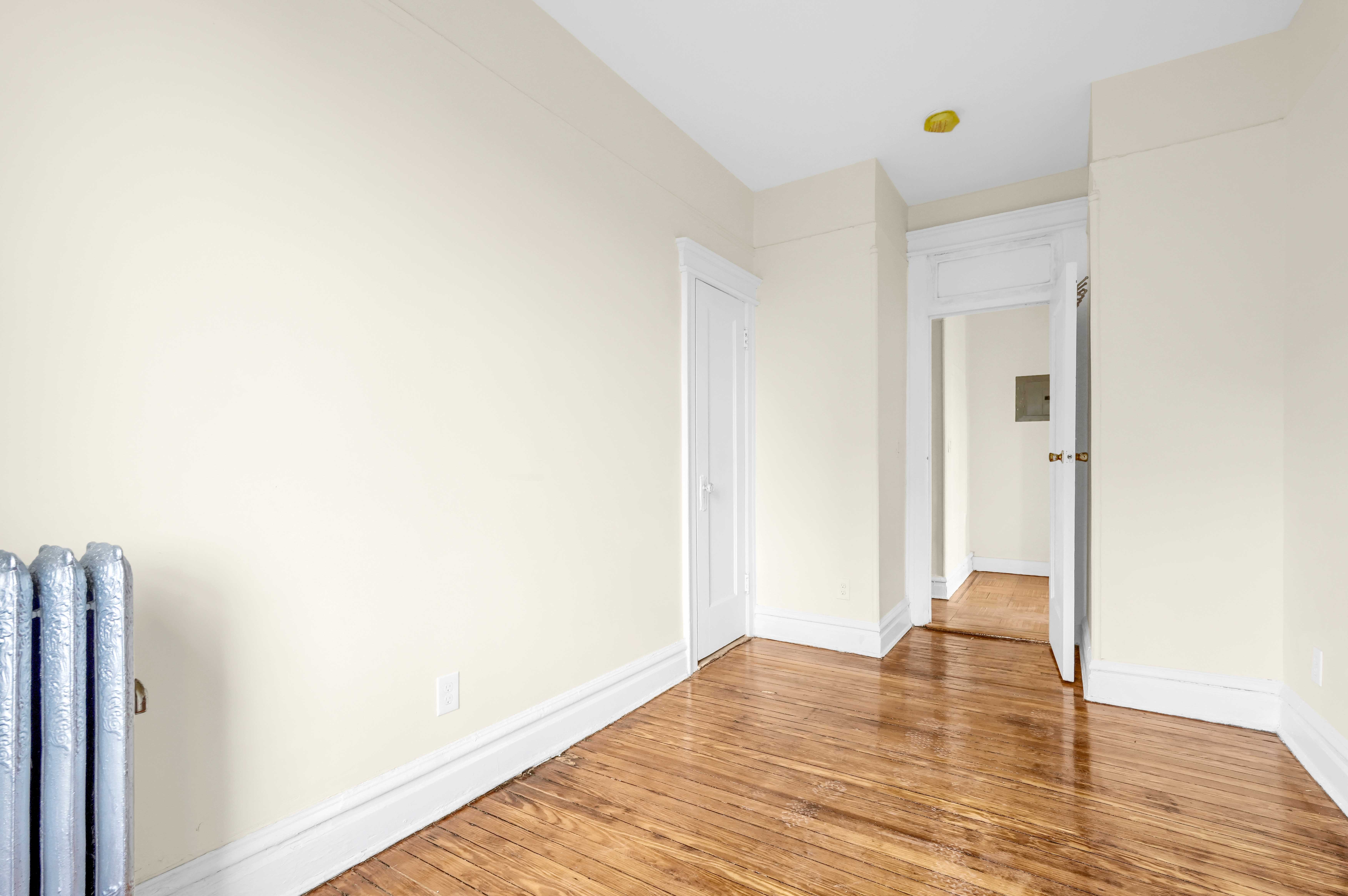 1770 Bedford Avenue Brooklyn, NY 11225 - Photo 29 of 50 a view of an empty room with wooden floor and closet