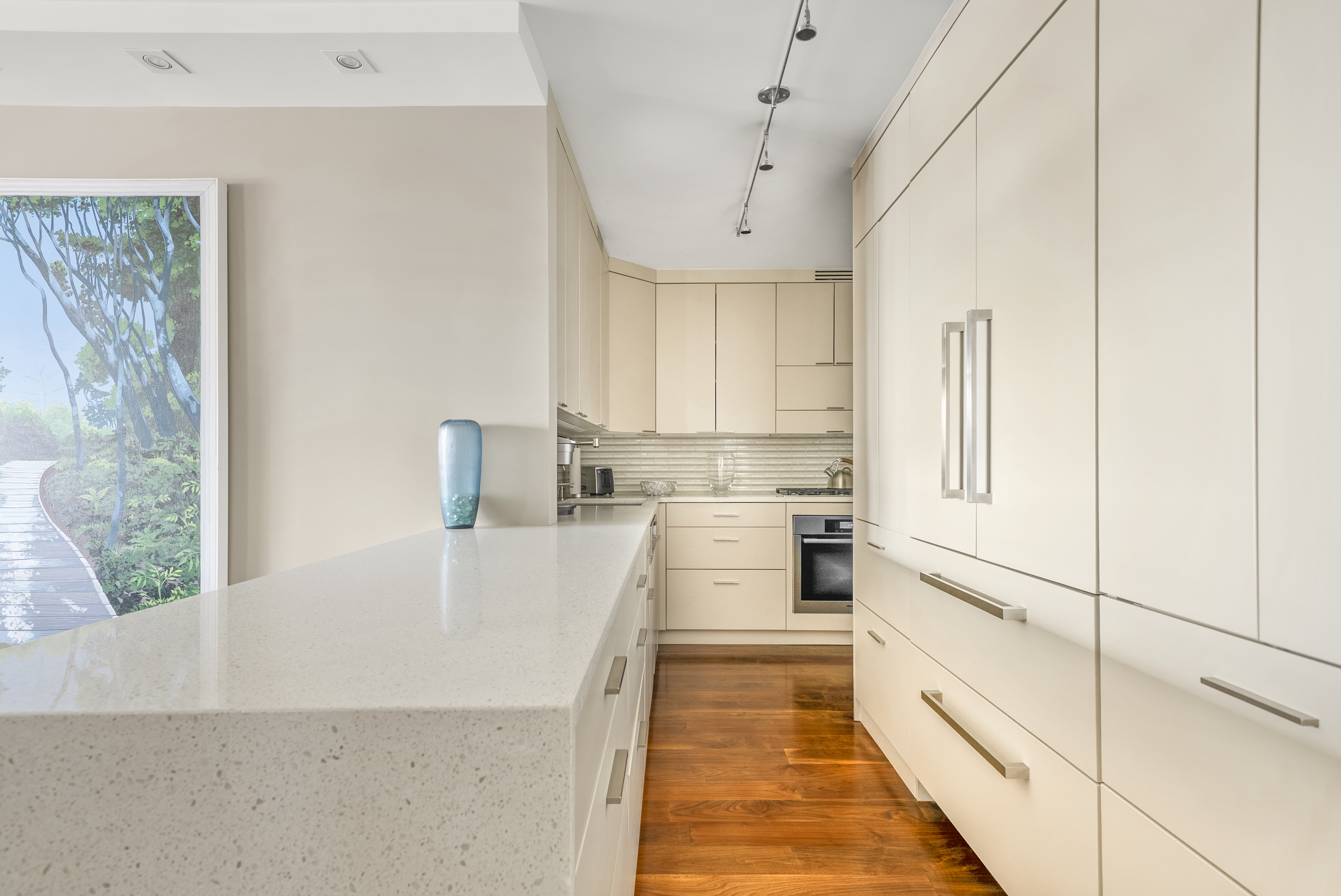 165 West 66th Street, Unit 18D Manhattan, NY 10023 - Photo 3 of 8 a kitchen with white cabinets and white appliances